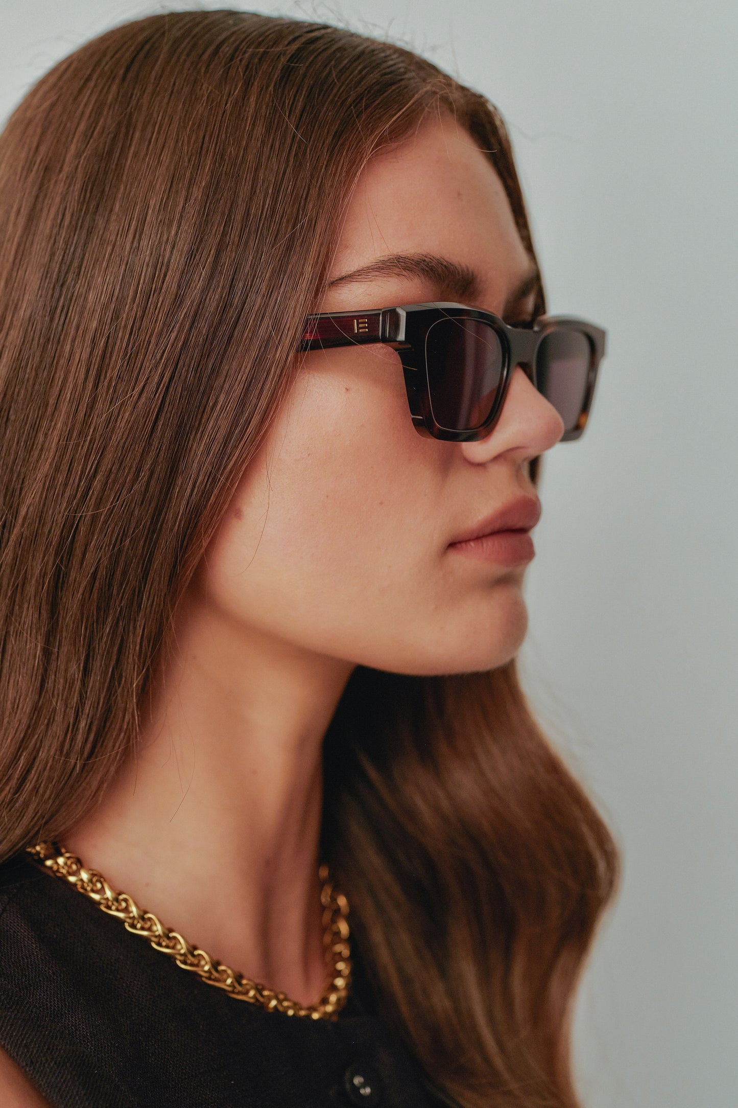 Model wearing Isle of Eden Brooklyn tortoise sunglasses, side profile portrait
