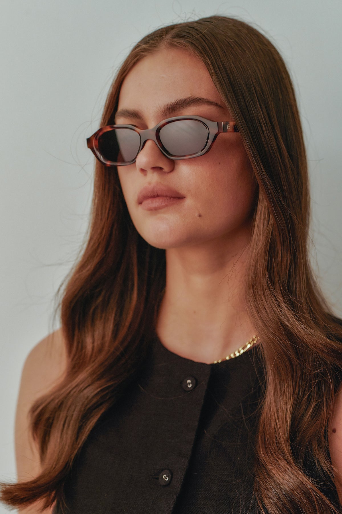 Female model wearing Isle of Eden Luca tortoise sunglasses, side profile portrait looking away