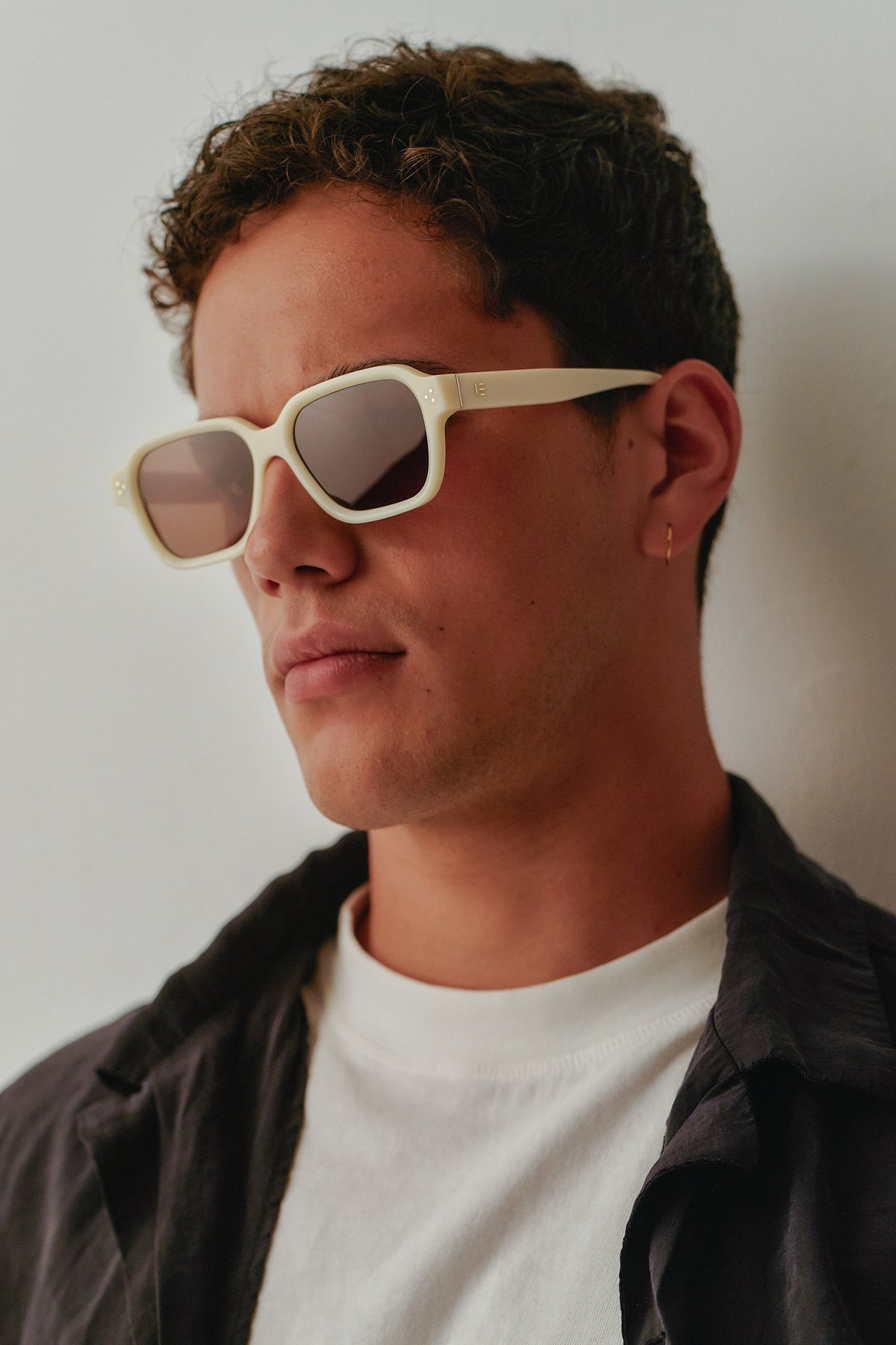 Male model wearing Isle of Eden Jamie ivory sunglasses, side profile portrait