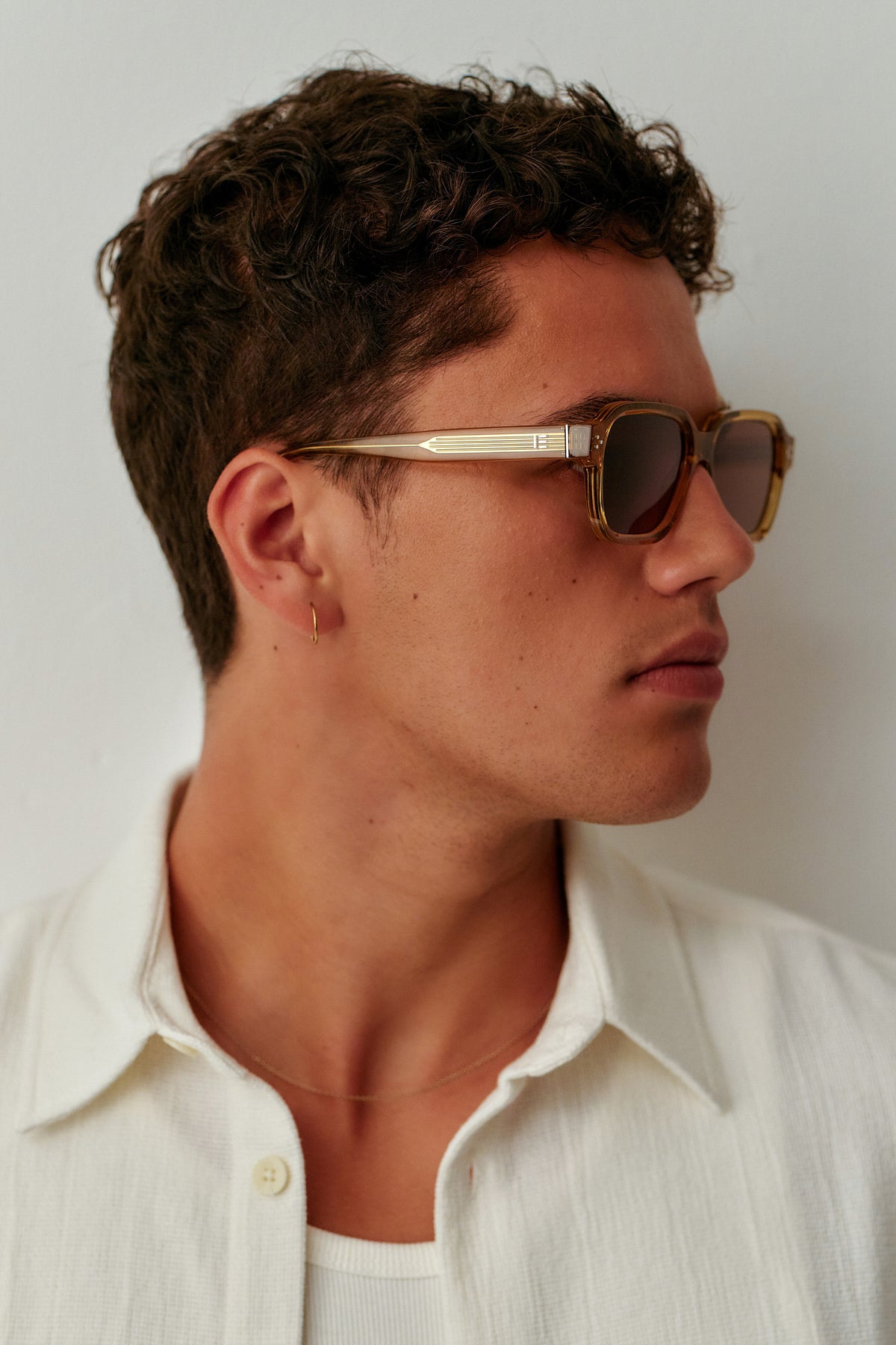 Male model wearing Isle of Eden Jamie cognac sunglasses, side profile portrait