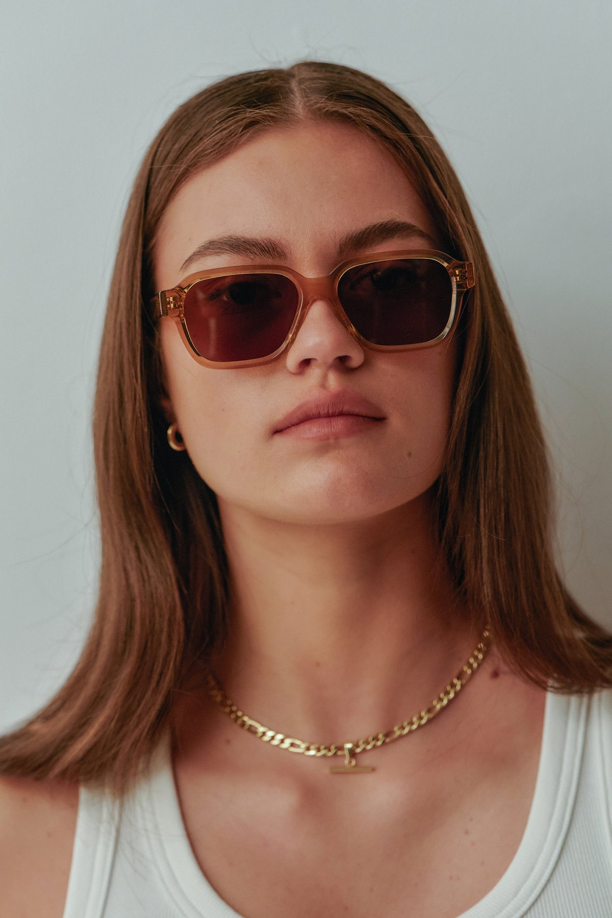 Female model wearing Isle of Eden Jamie cognac sunglasses, close front-facing portrait
