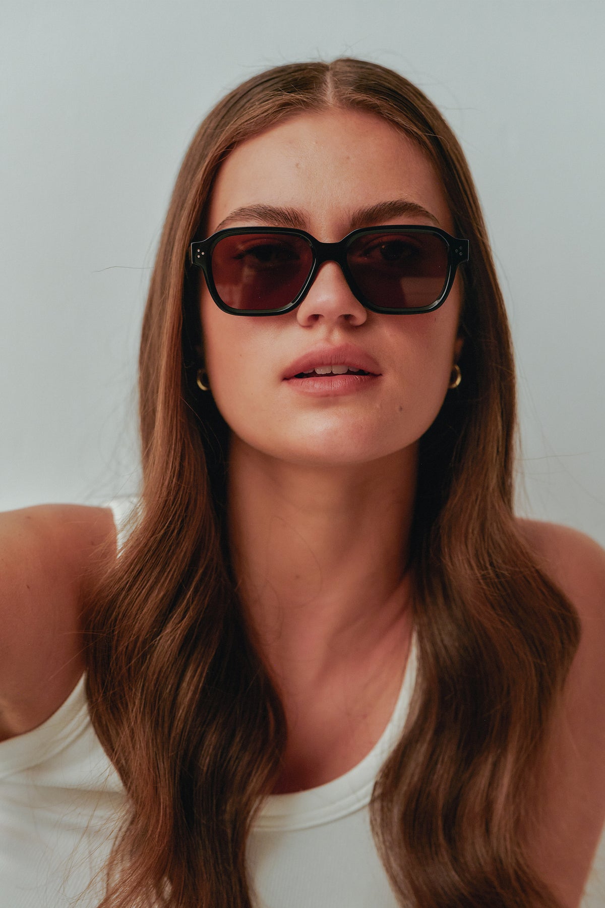 Female model wearing Isle of Eden Jamie black sunglasses, close front-facing portrait