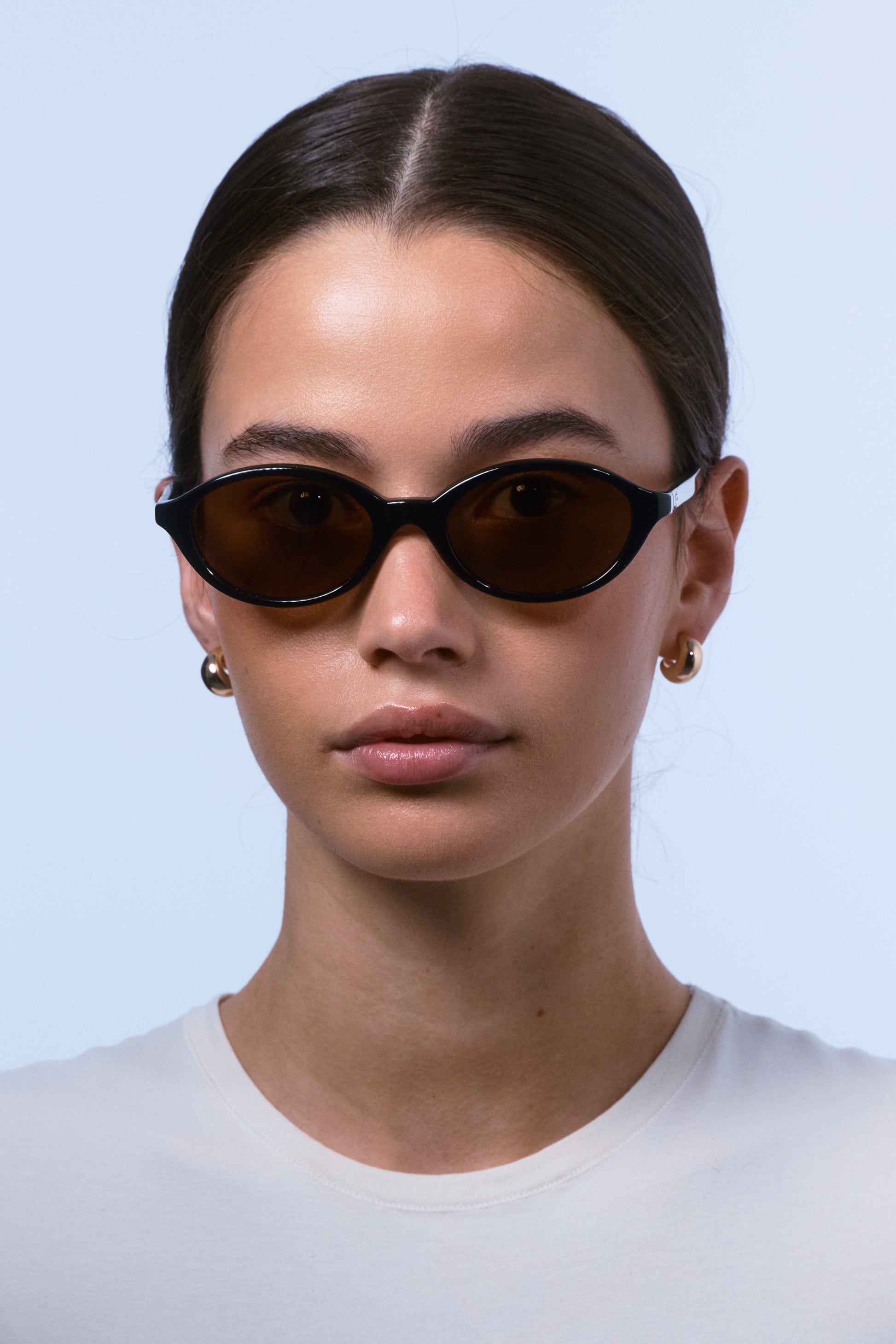 Female model wearing Isle of Eden Mirabel black sunglasses, close front-facing portrait