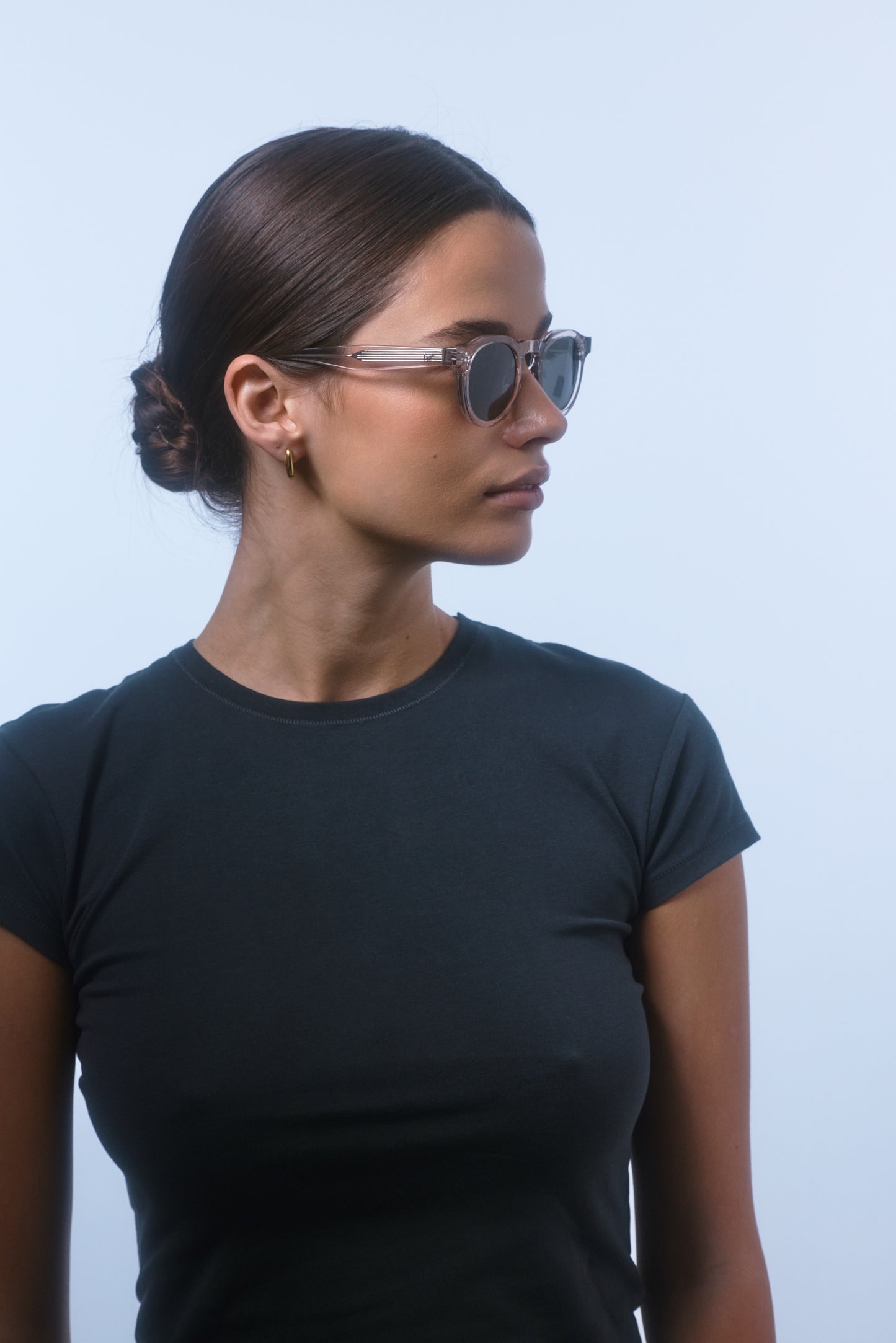 Side profile of a female model wearing Isle of Eden Drew sand Prescription unisex sunglasses.