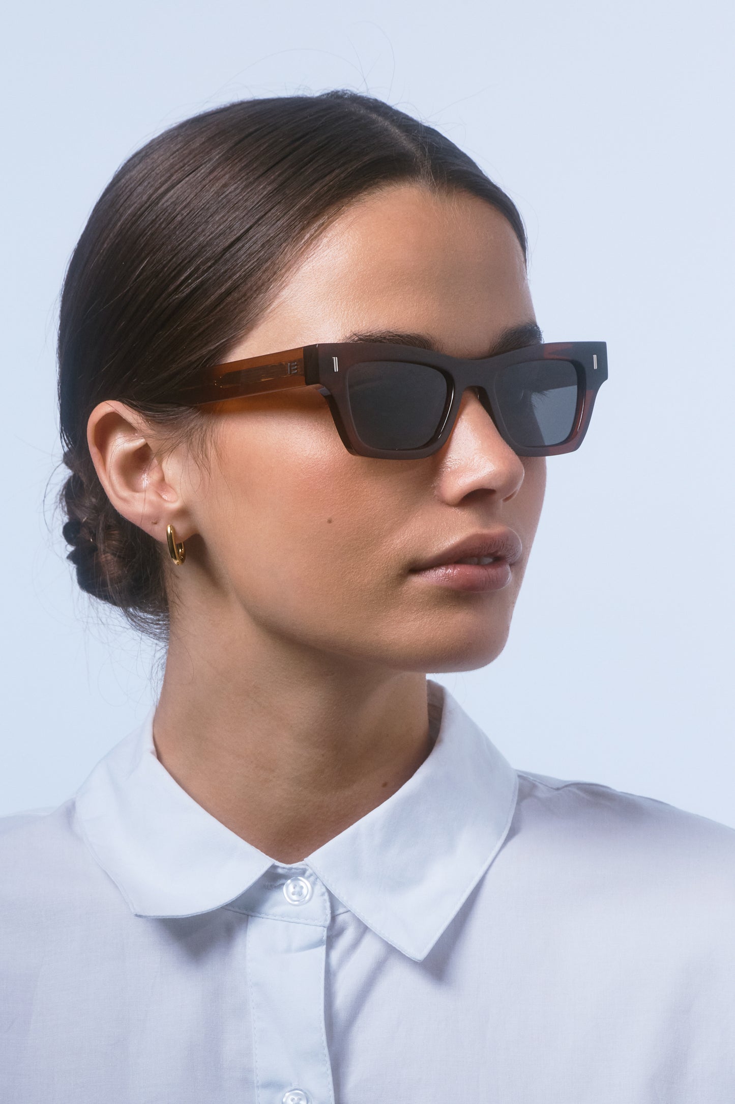 Female model wearing Isle of Eden Olli brown sunglasses, angled portrait looking away
