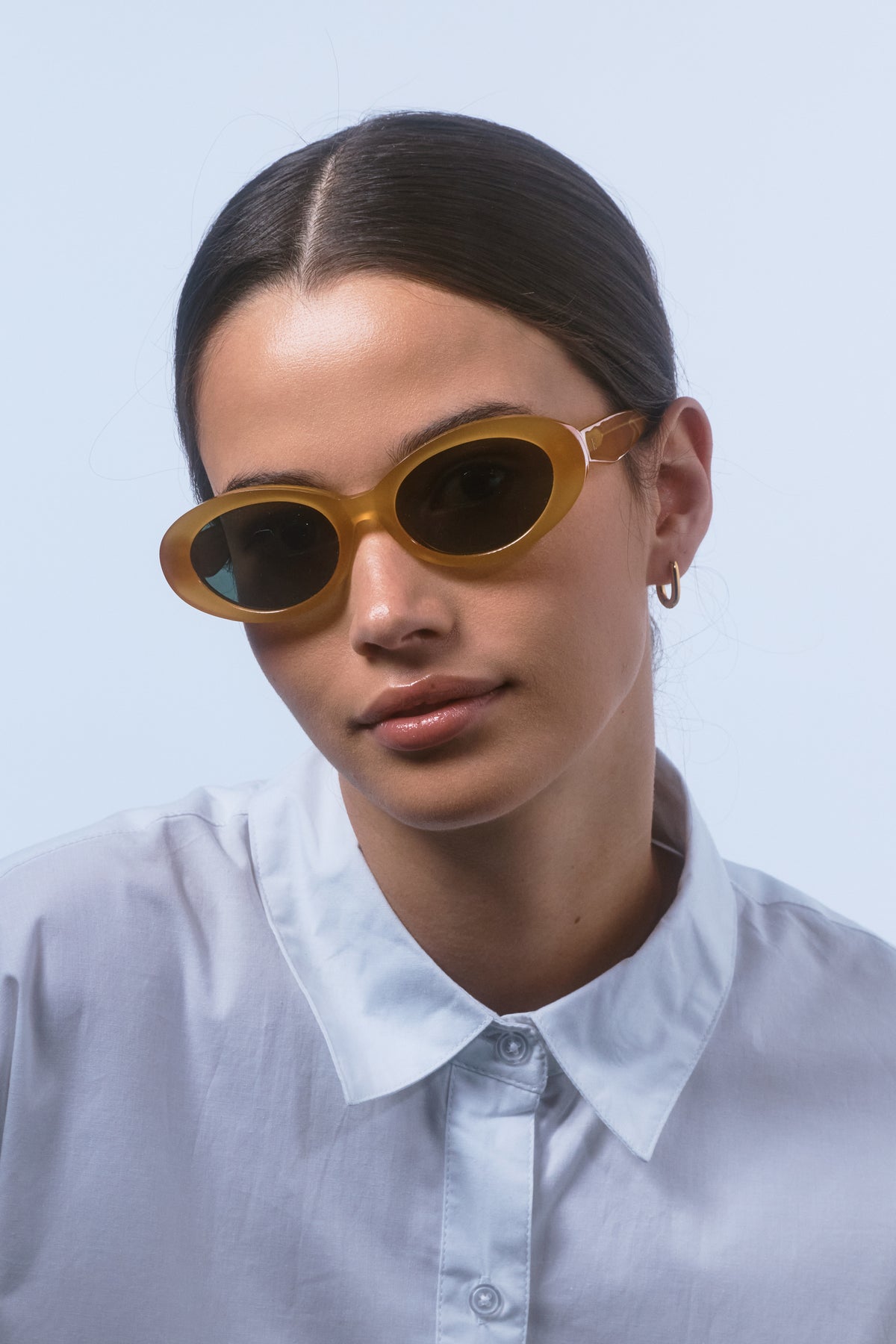 Female model wearing Isle of Eden Frankie yellow sunglasses, close front-facing portrait