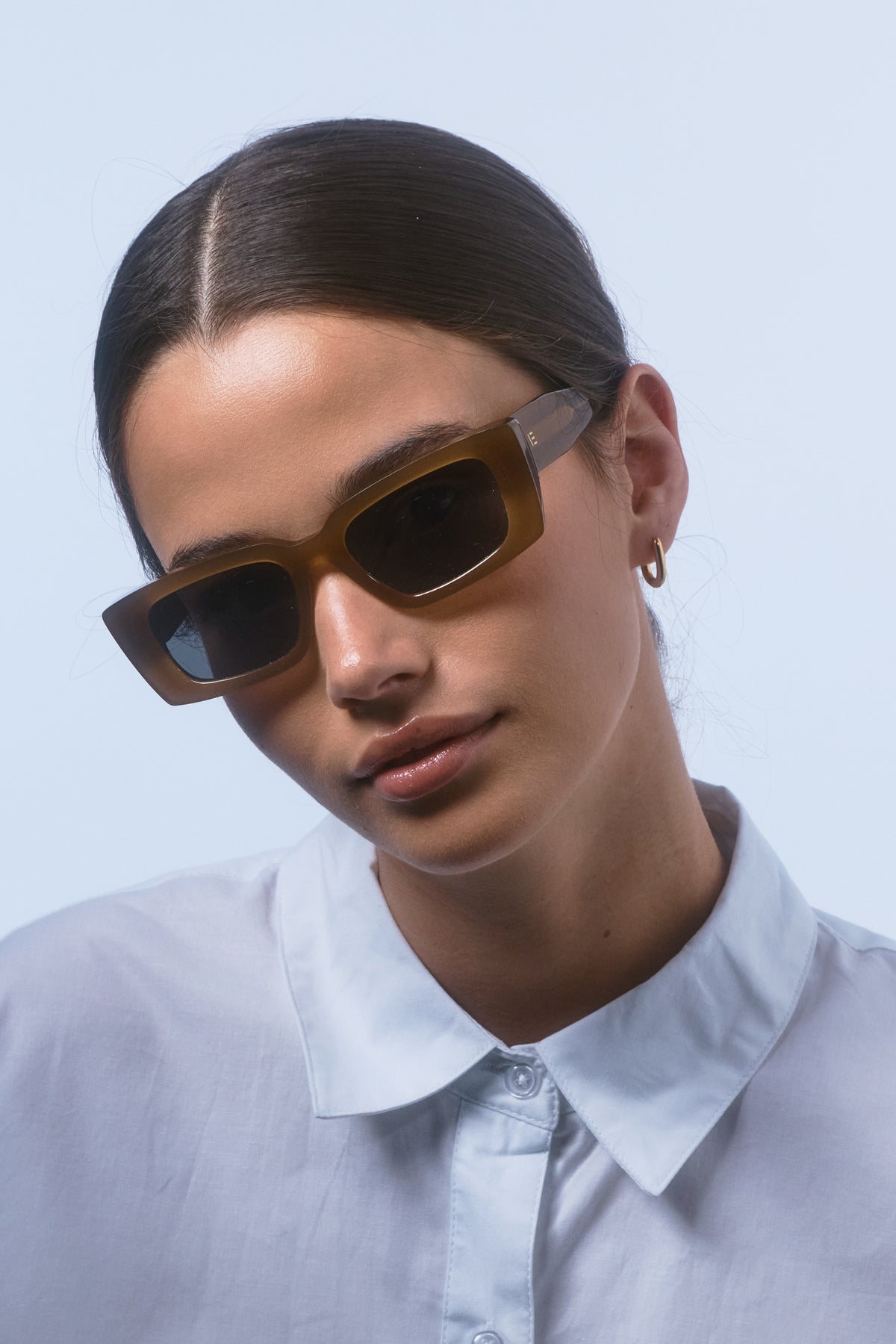 Female model wearing Isle of Eden Goldie dijon sunglasses, close front-facing portrait