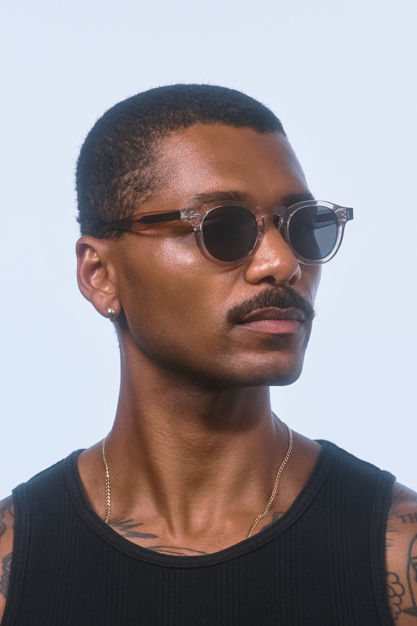 Male model wearing Isle of Eden Drew sand sunglasses, angled portrait