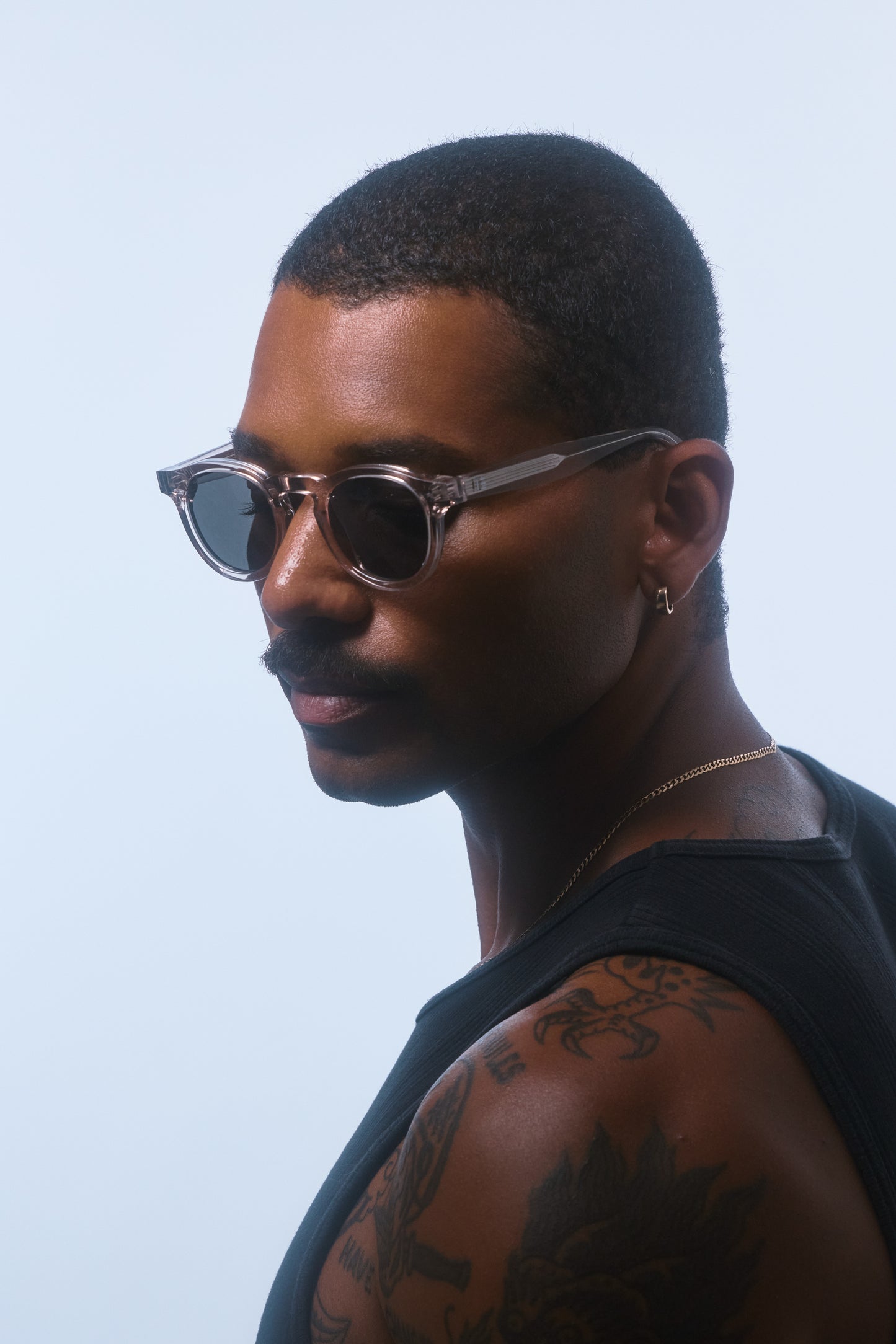 Side profile of a male model wearing Isle of Eden Drew Sand or clear colour Prescription unisex sunglasses.