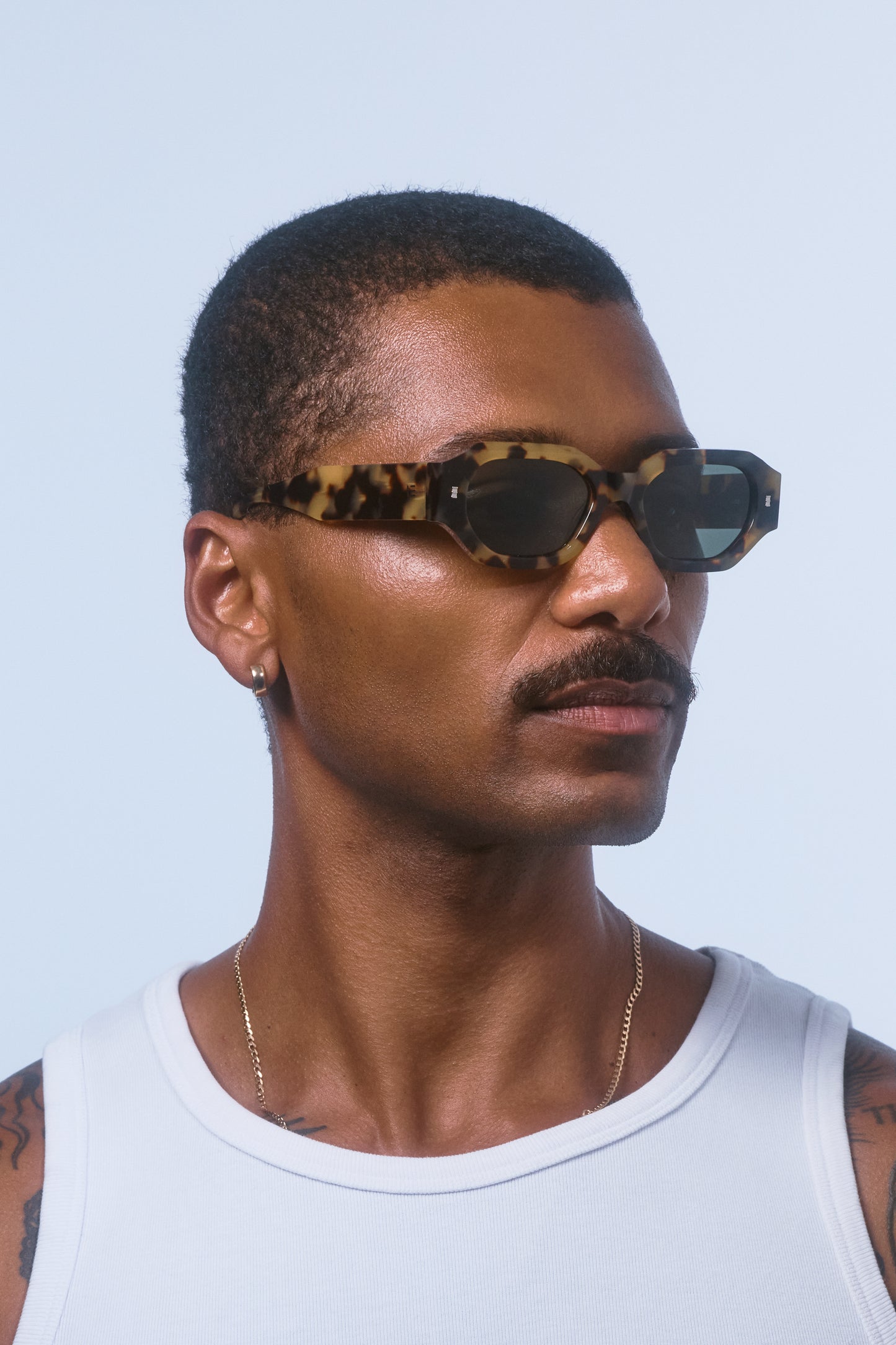 Male model wearing Isle of Eden Blake tortoise sunglasses, angled side profile portrait