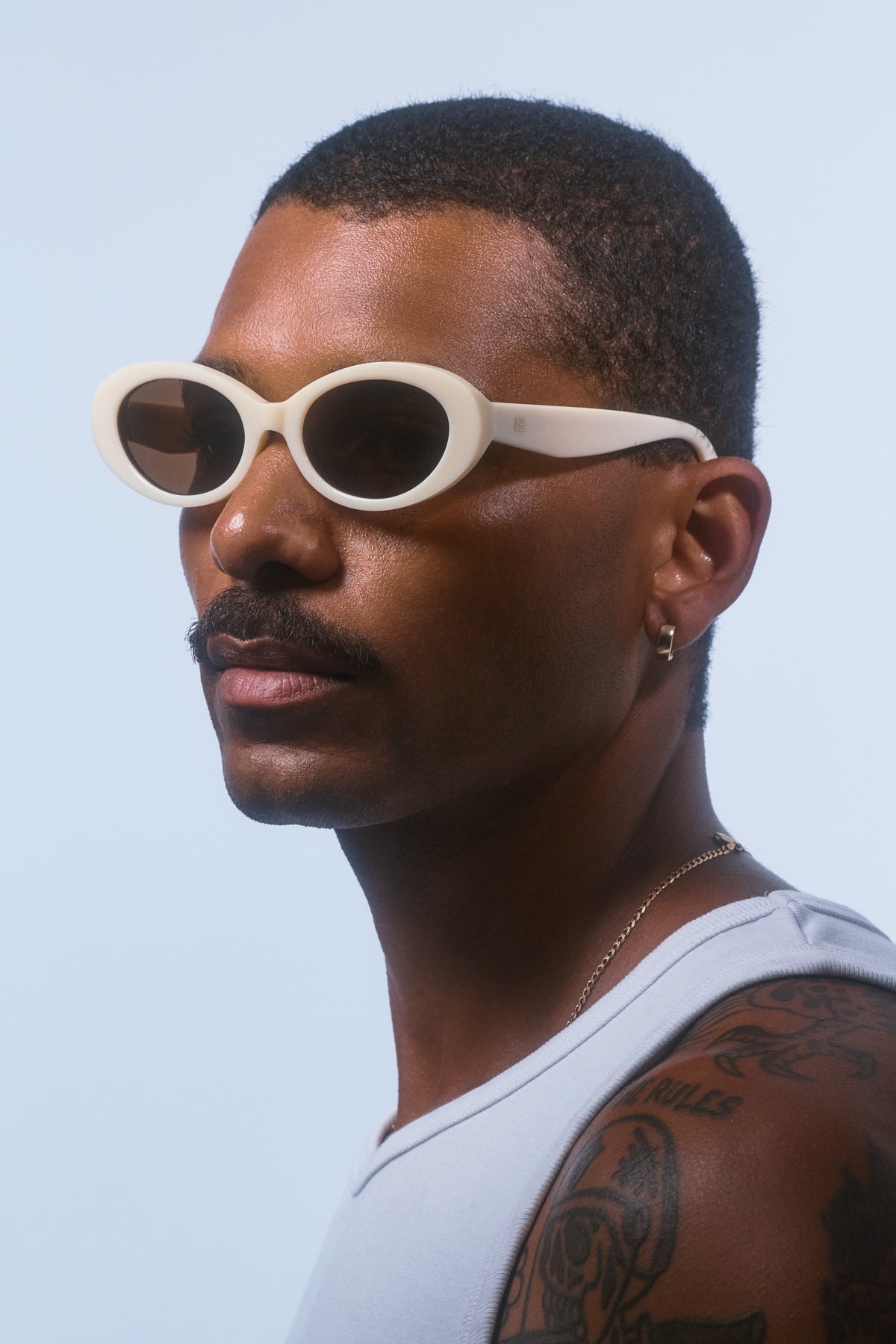 Male model wearing Isle of Eden Frankie ivory sunglasses, angled portrait