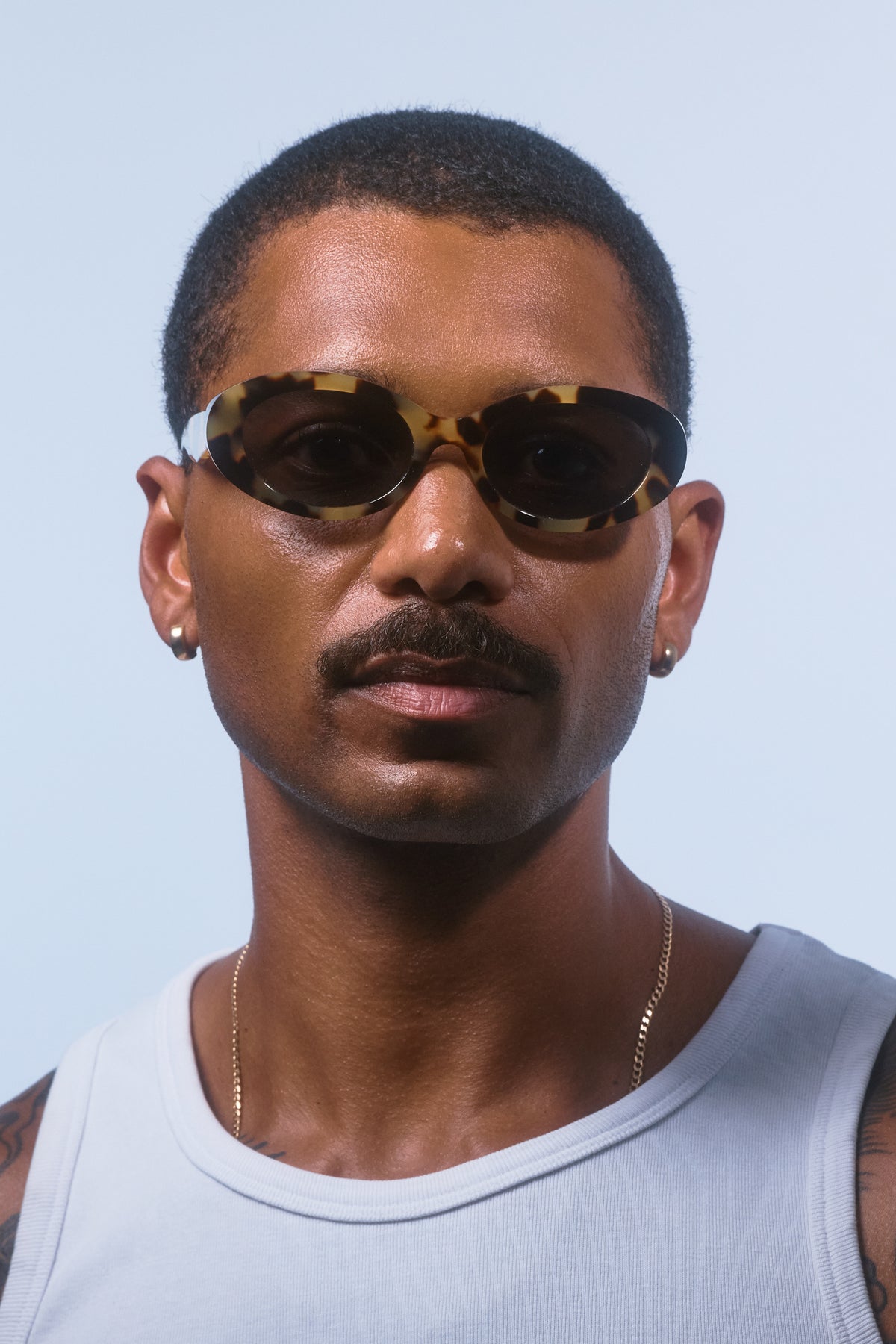 Male model wearing Isle of Eden Frankie tortoise sunglasses, front-facing portrait looking directly at the camera
