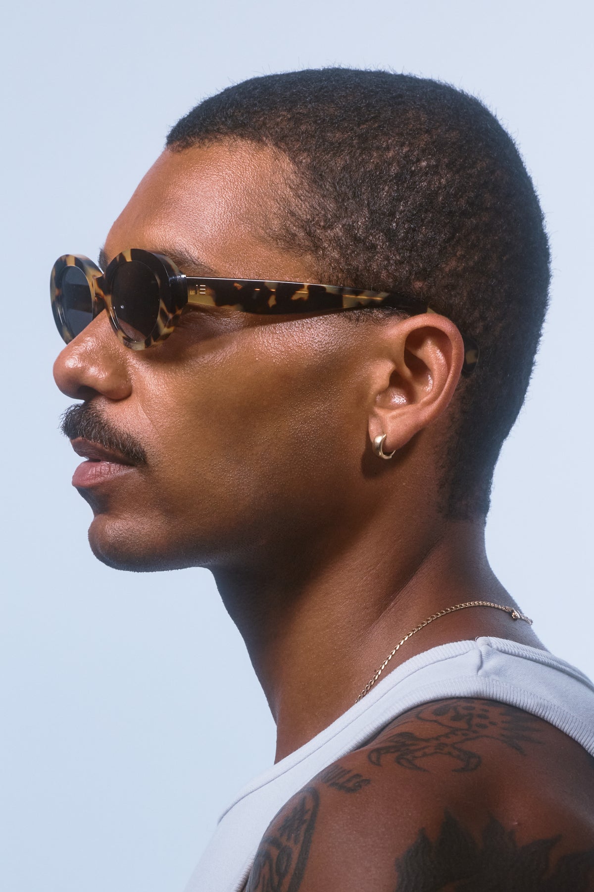 Male model wearing Isle of Eden Frankie tortoise sunglasses, side profile portrait