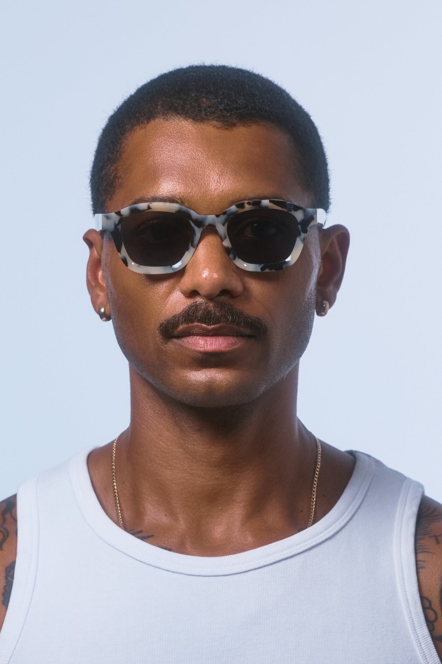 Male model wearing Isle of Eden Harley white tortoise sunglasses, close front-facing portrait