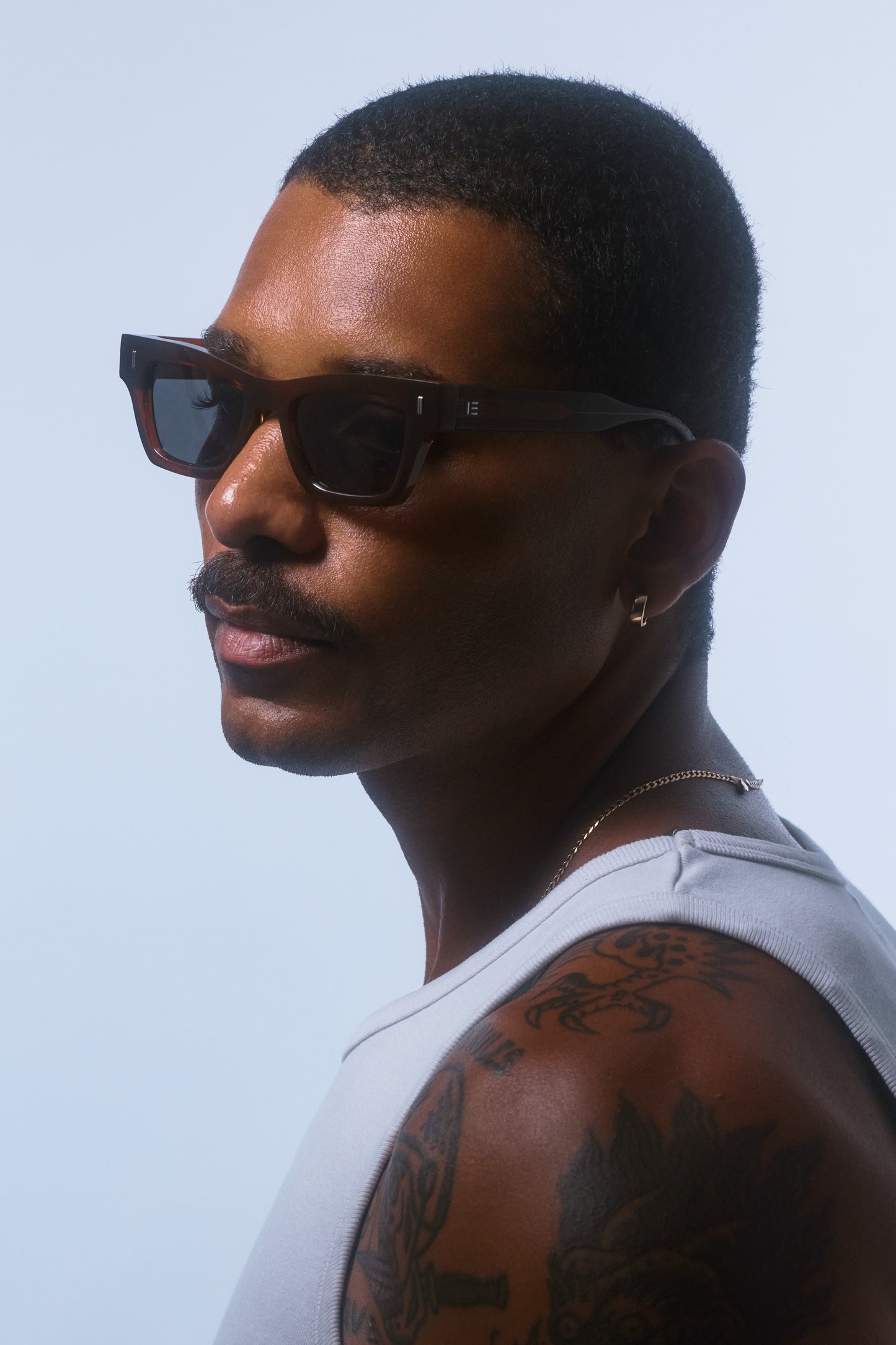Male model wearing Isle of Eden Olli brown sunglasses, side profile portrait