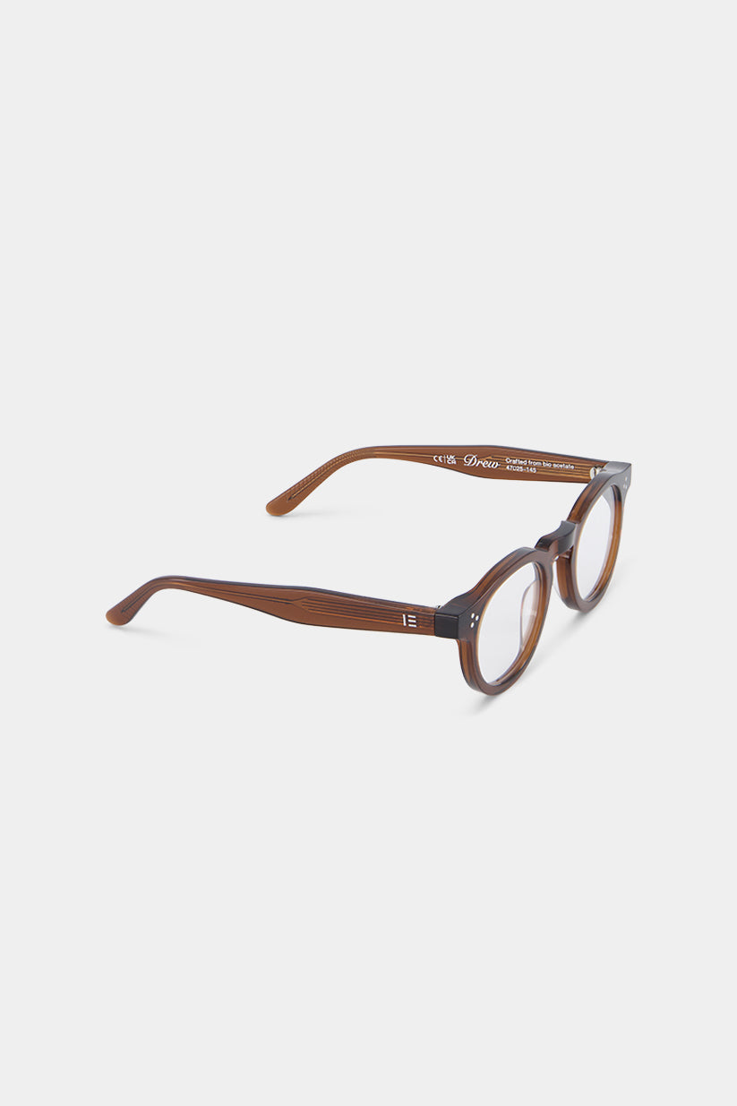 Isle of Eden Drew prescription glasses, close-up three-quarter angle showing the eco-conscious bio-acetate wood-grain frame texture and hinge detail