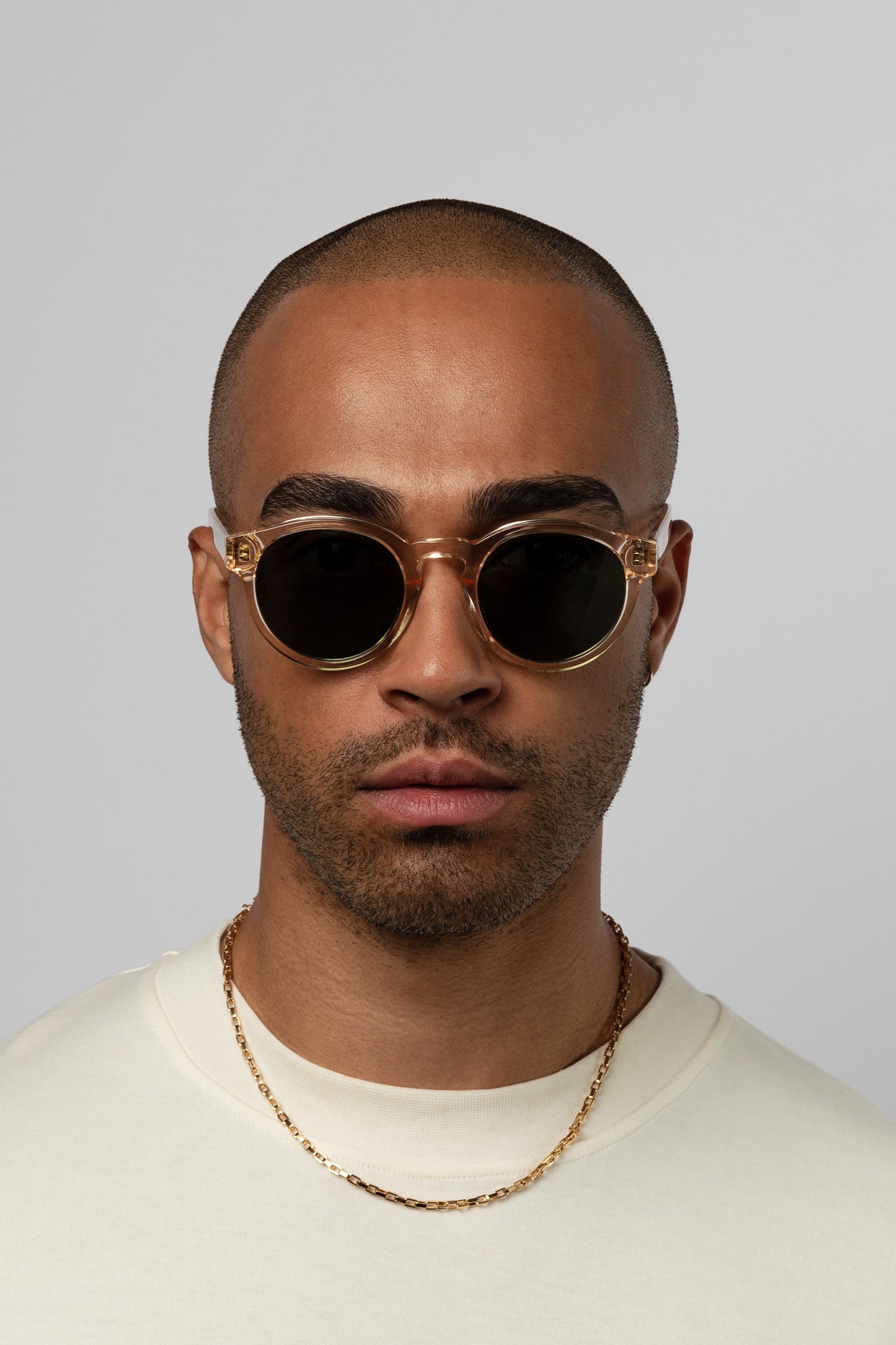 Male model wearing Isle of Eden Eddie champagne sunglasses, front-facing portrait