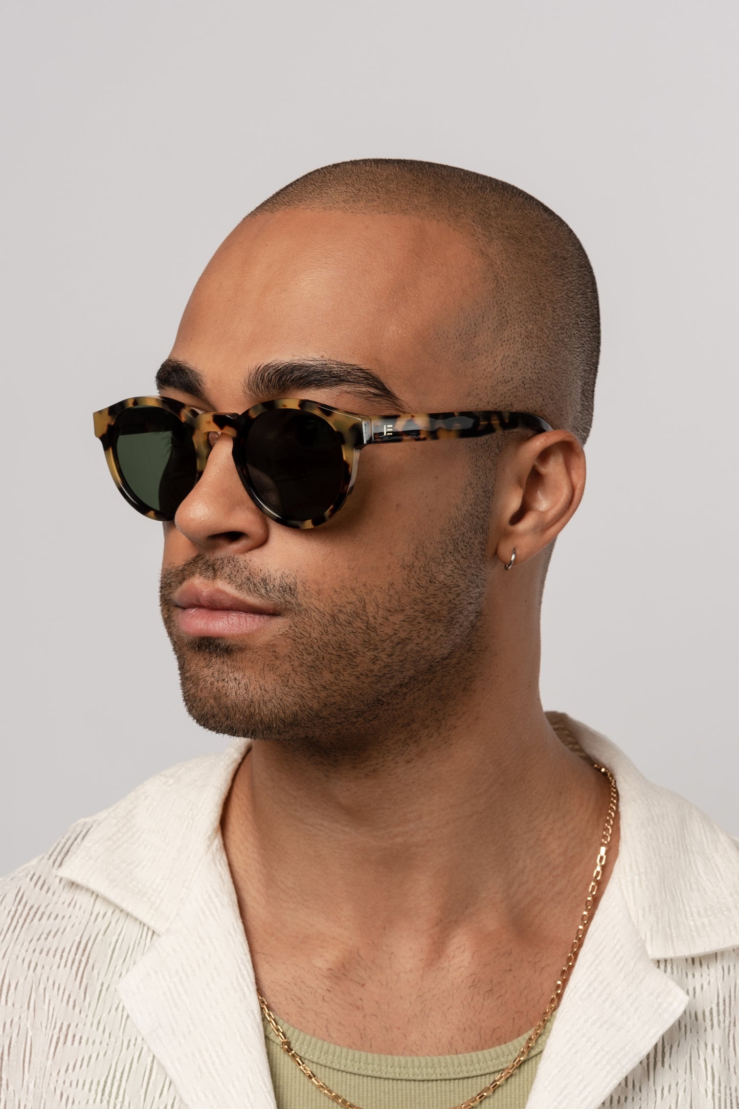 Male model wearing Isle of Eden Eddie tortoise sunglasses, angled portrait