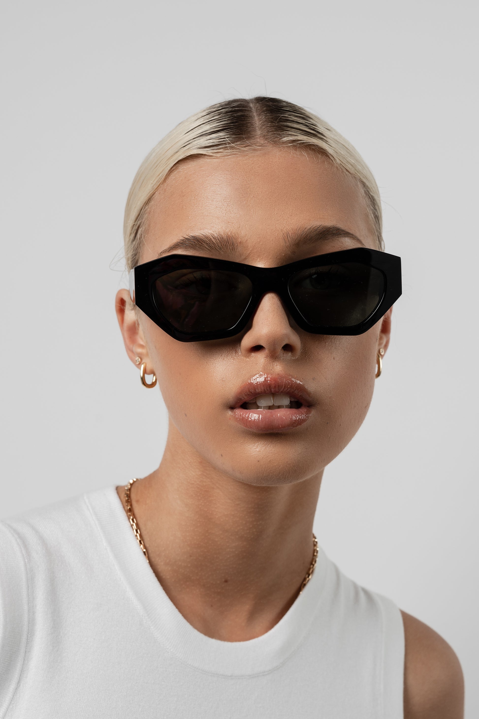 Female model wearing Isle of Eden Emily black sunglasses, front-facing portrait