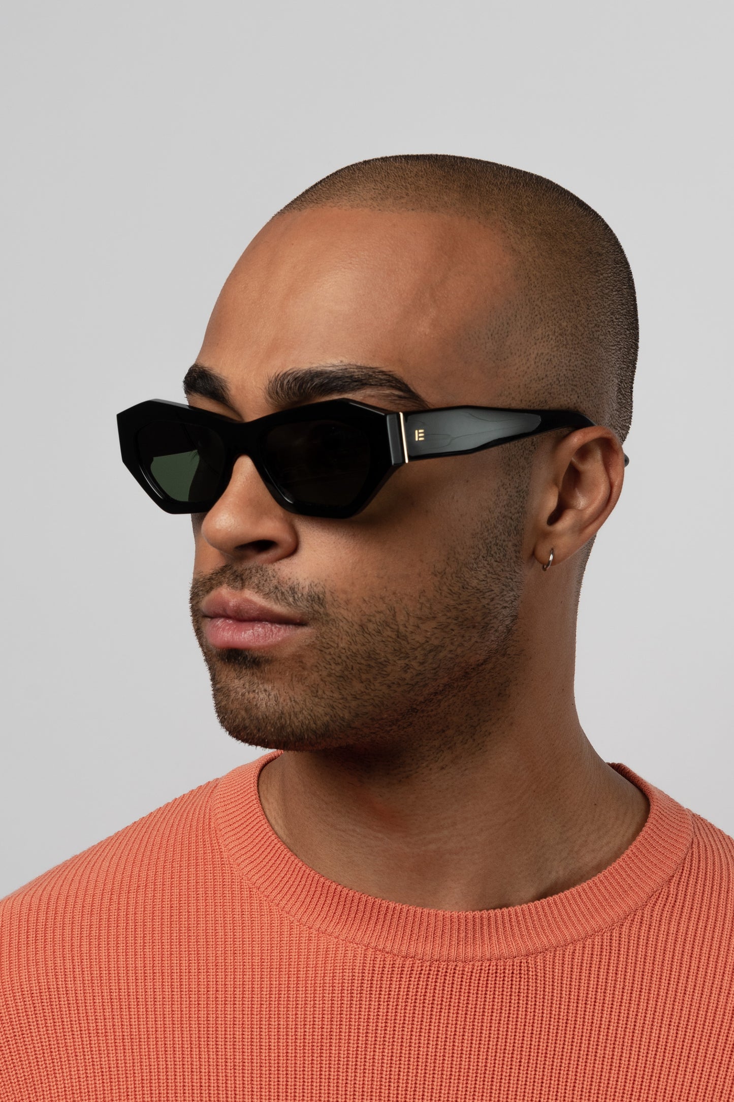 Male model wearing Isle of Eden Emily black sunglasses, angled portrait