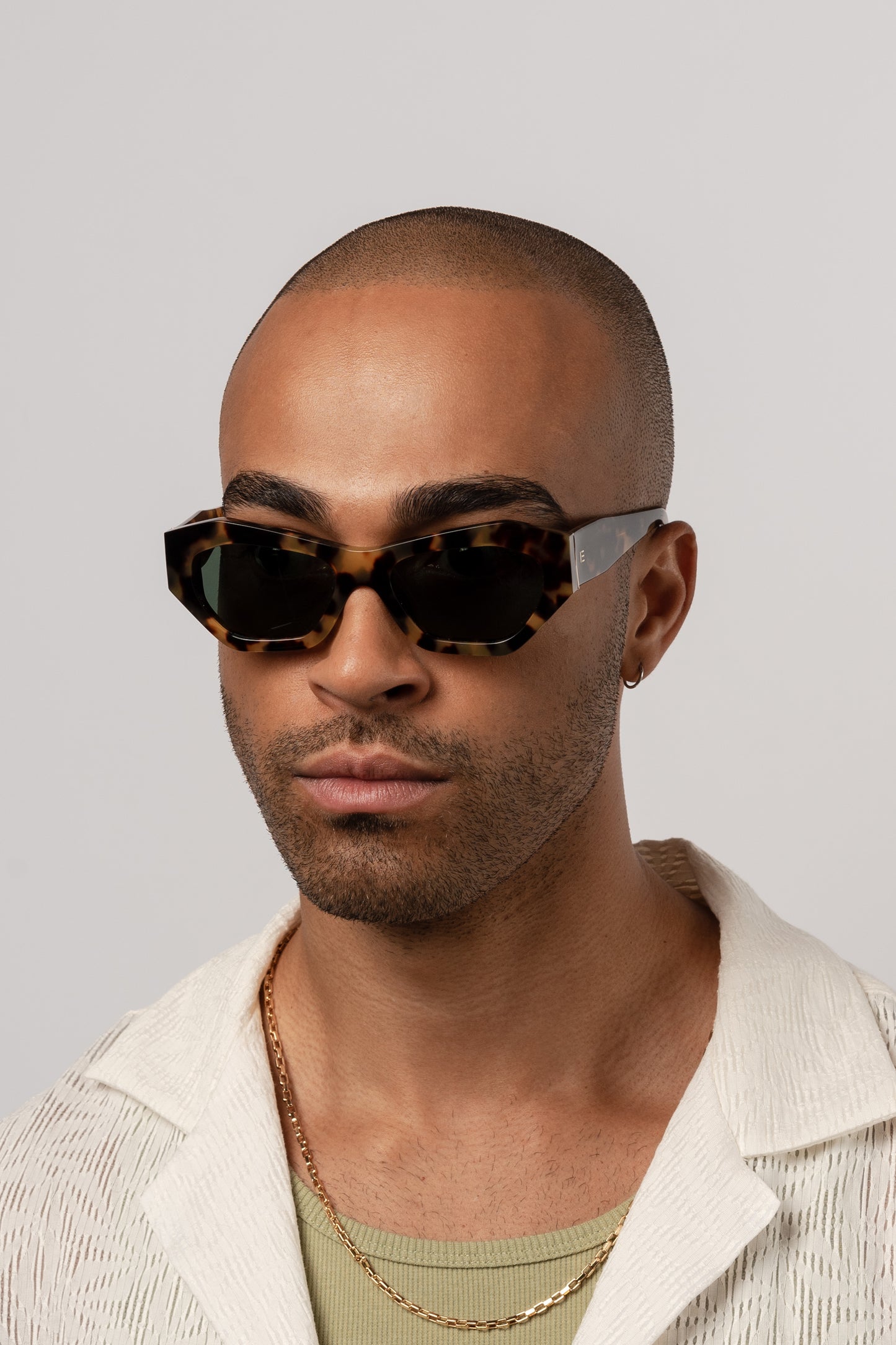 Male model wearing Isle of Eden Emily tortoise sunglasses, front-facing portrait