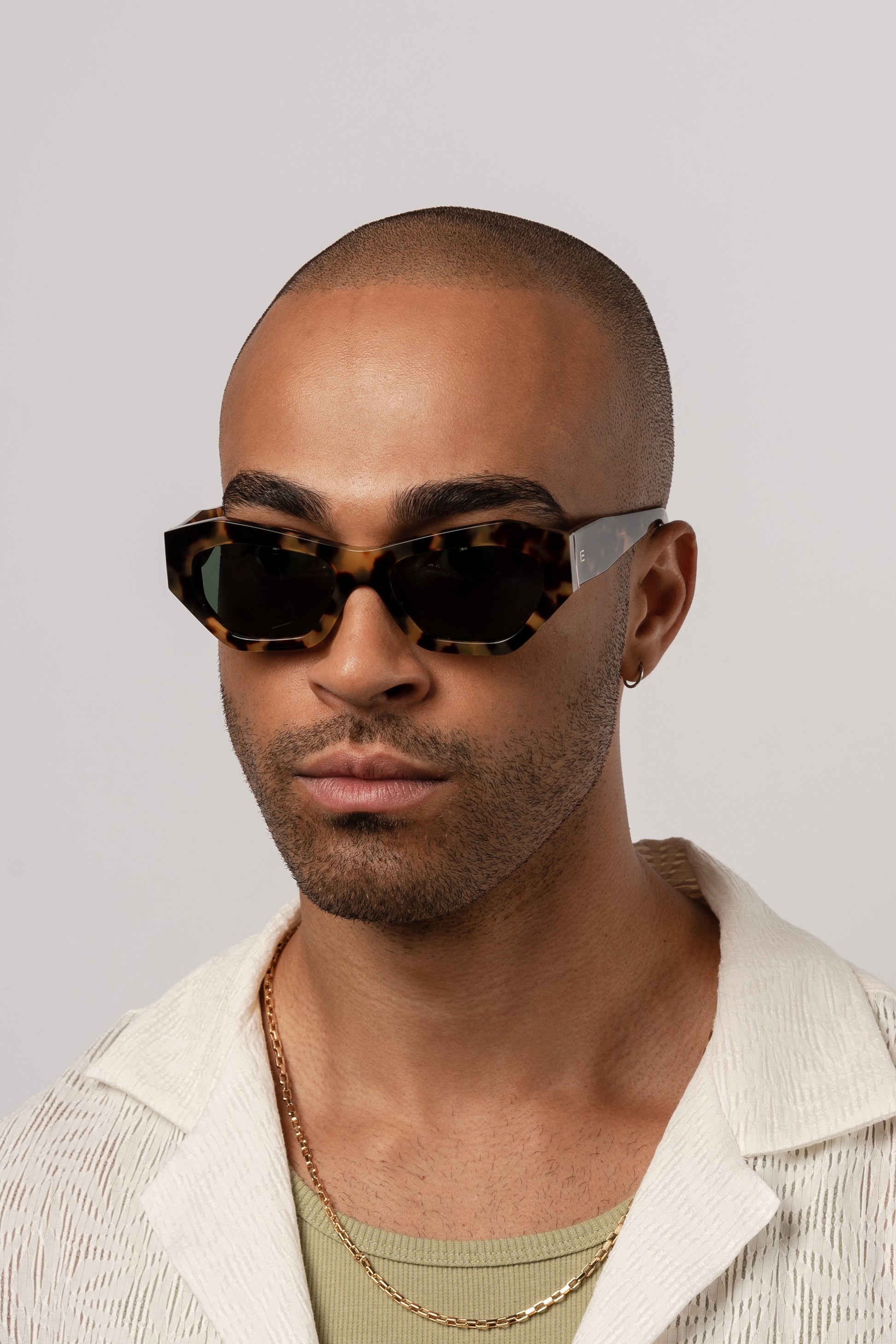 Male model wearing Isle of Eden Emily tortoise sunglasses, front-facing portrait