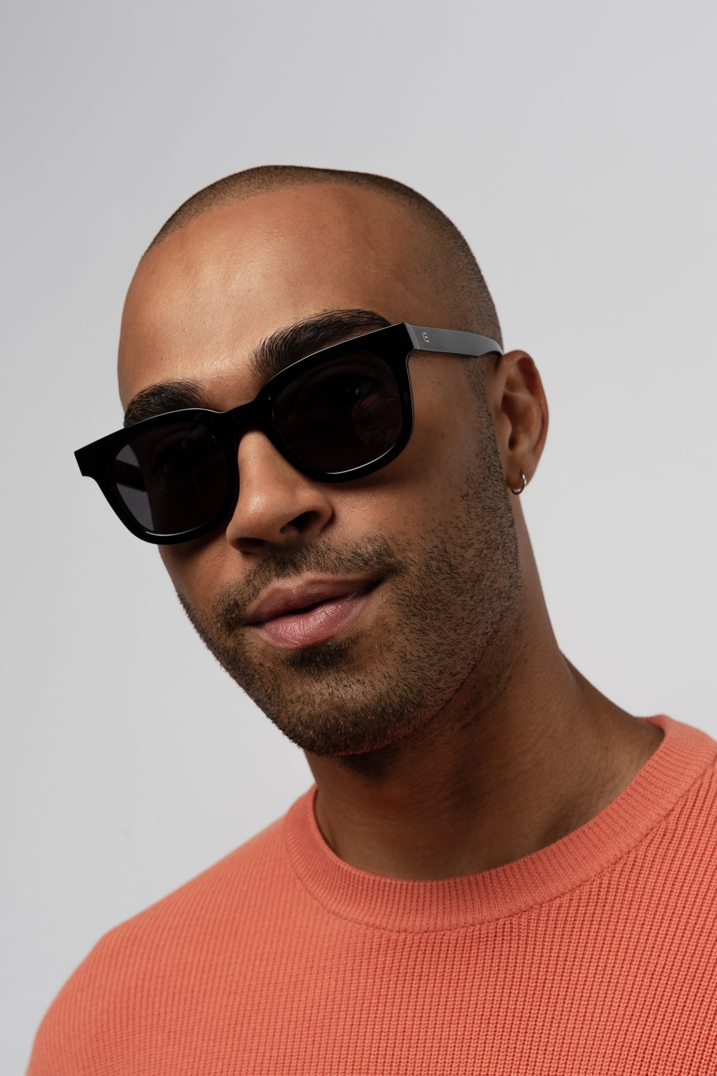 Male model wearing Isle of Eden Eugene black sunglasses, front-facing portrait