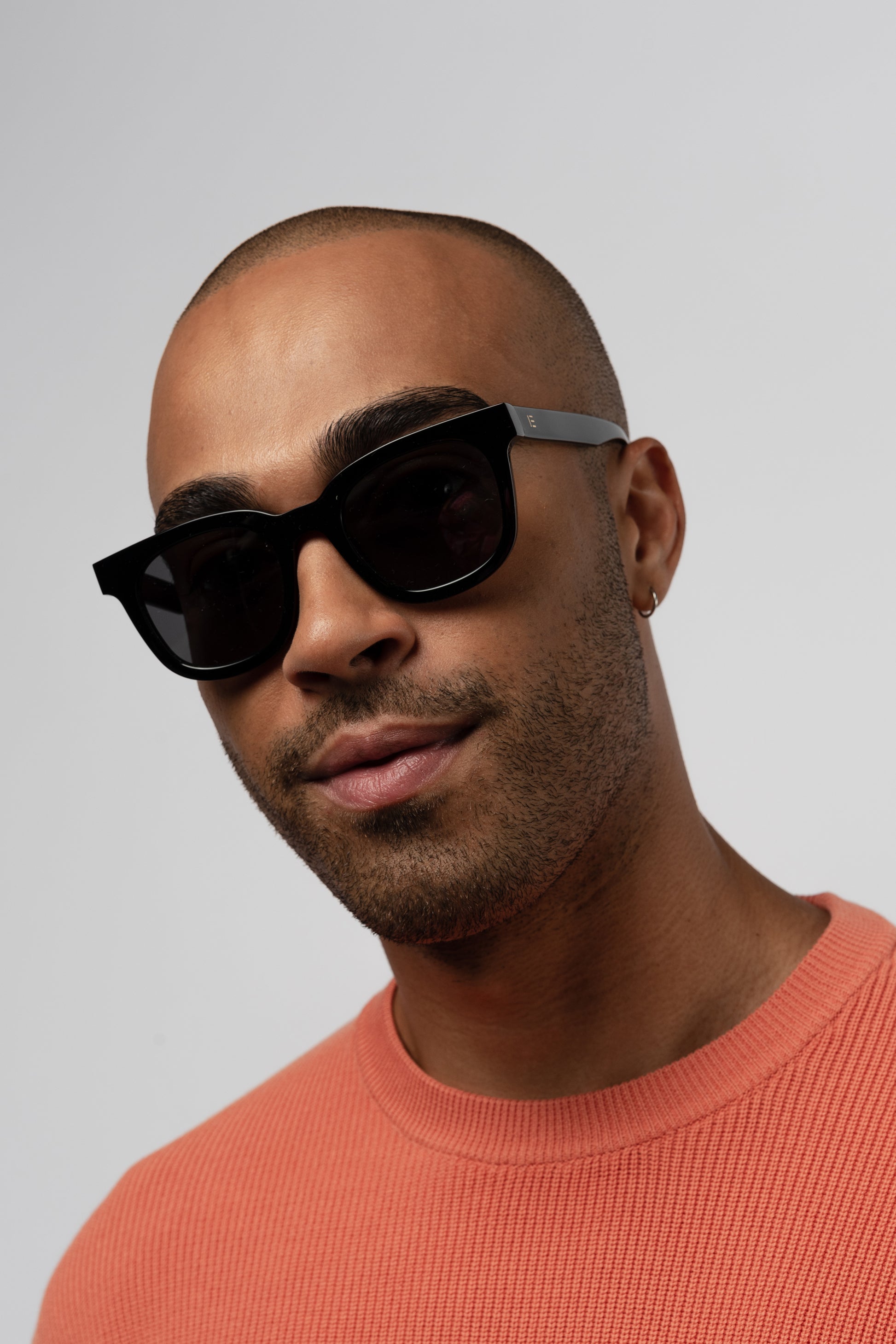 Male model wearing Isle of Eden Eugene black sunglasses, front-facing portrait