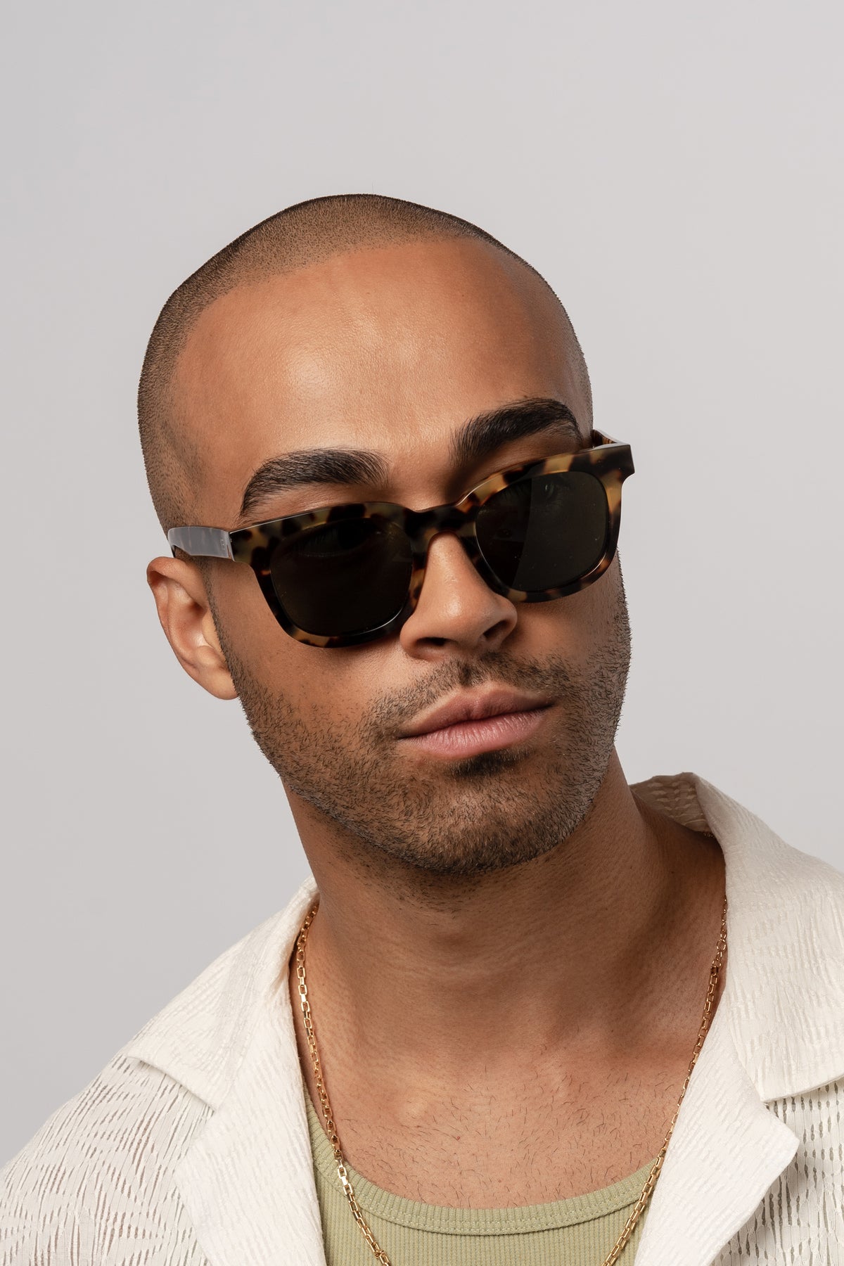 Male model wearing Isle of Eden Eugene tortoise sunglasses, front-facing portrait looking directly at the camera