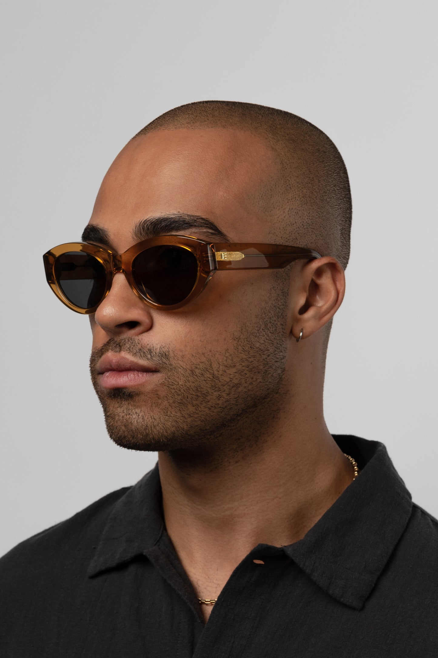 Male model wearing Isle of Eden Felina cognac sunglasses, angled portrait