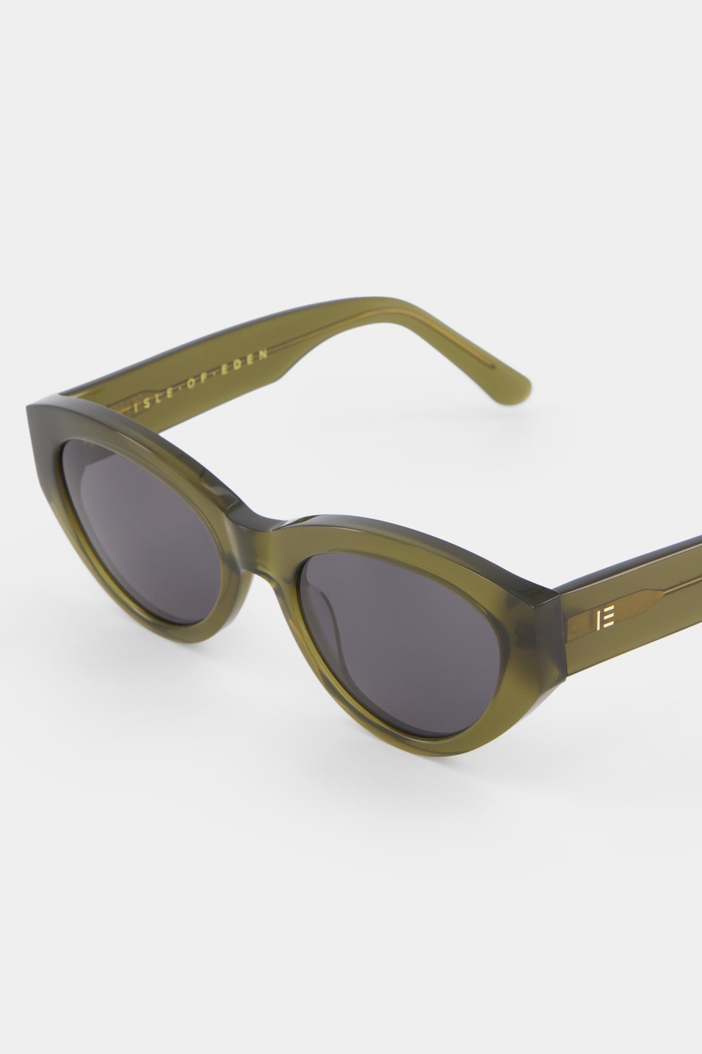 Close-up of Isle of Eden Felina frosted green sunglasses showing cat-eye frame and brand lettering