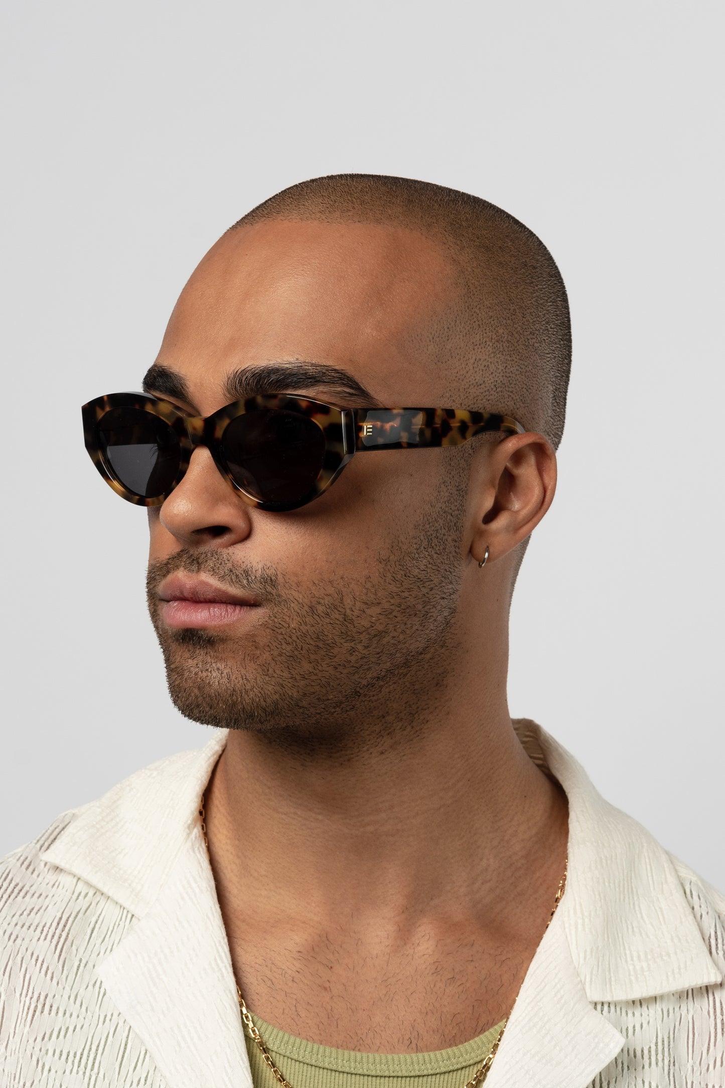 Male model wearing Isle of Eden Felina tortoise sunglasses, angled portrait