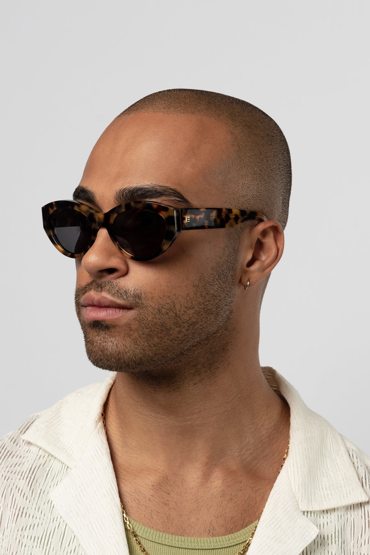 Male model wearing Isle of Eden Felina tortoise sunglasses, angled portrait