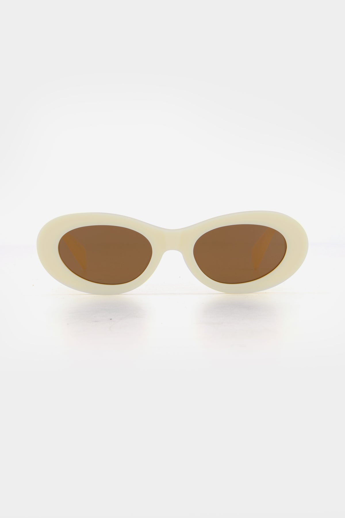 Isle of Eden Frankie ivory sunglasses, front view showing curvy oval frame and brown lenses