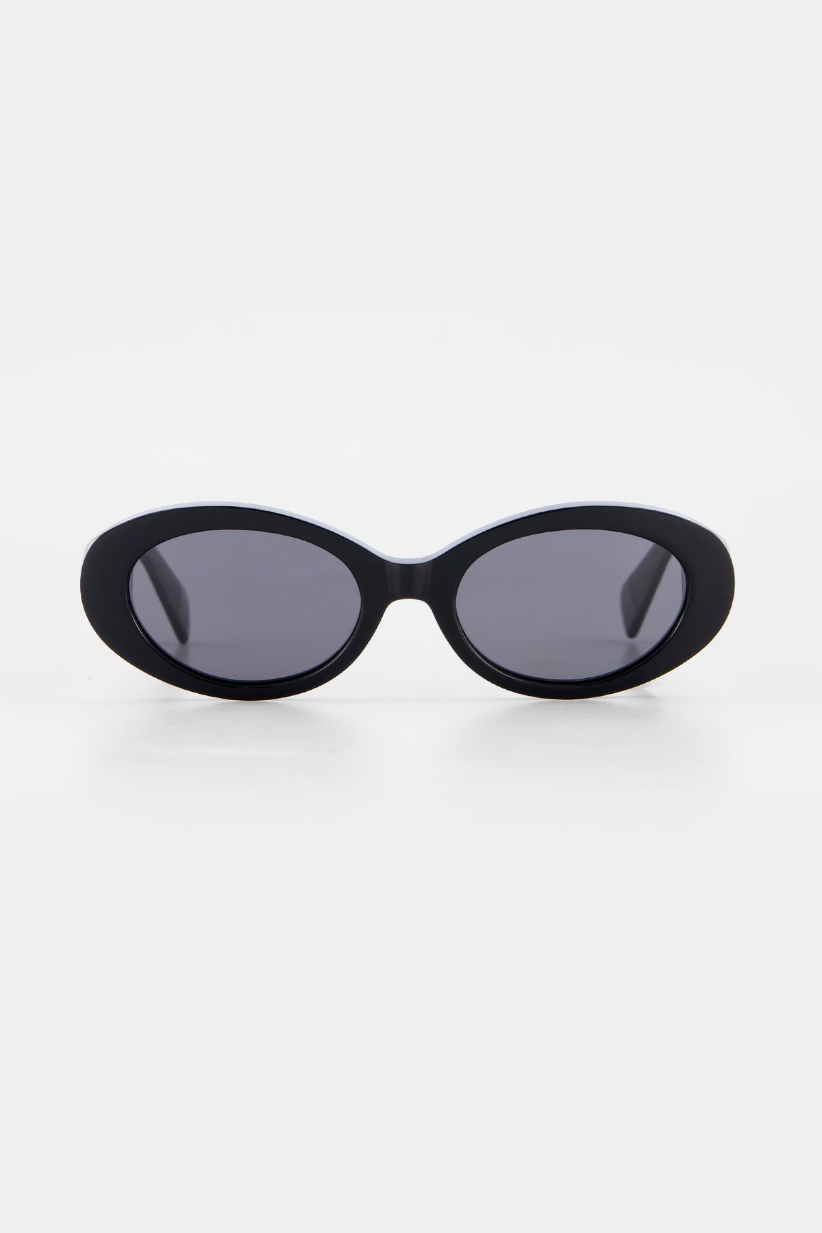 Isle of Eden Frankie black sunglasses, front view showing curvy oval frame and dark lenses