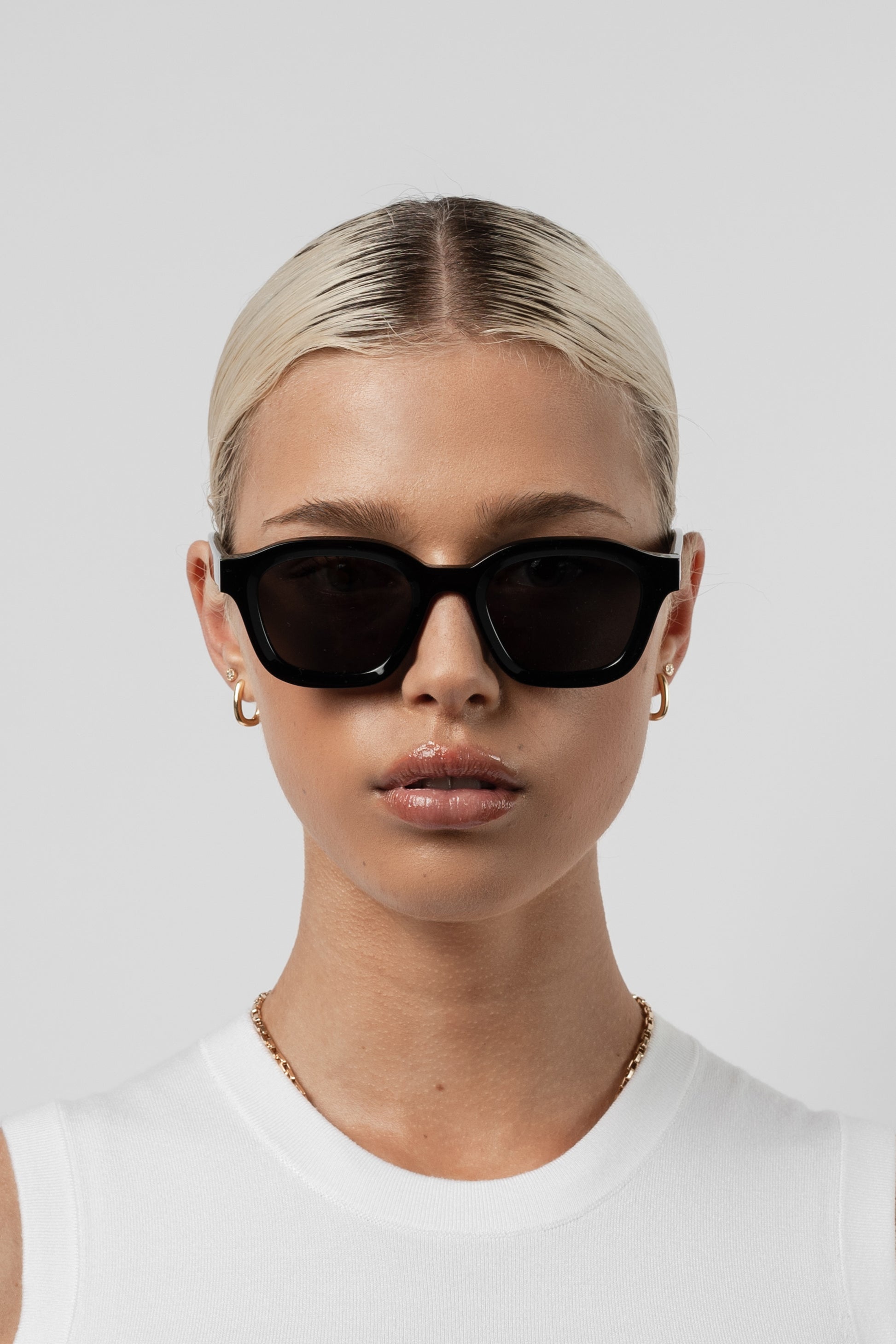 Female model wearing Isle of Eden Harley black sunglasses, front-facing portrait
