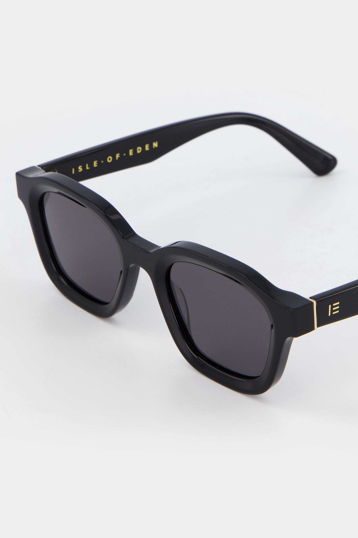 Close-up of Isle of Eden Harley black sunglasses showing bold frame and brand lettering