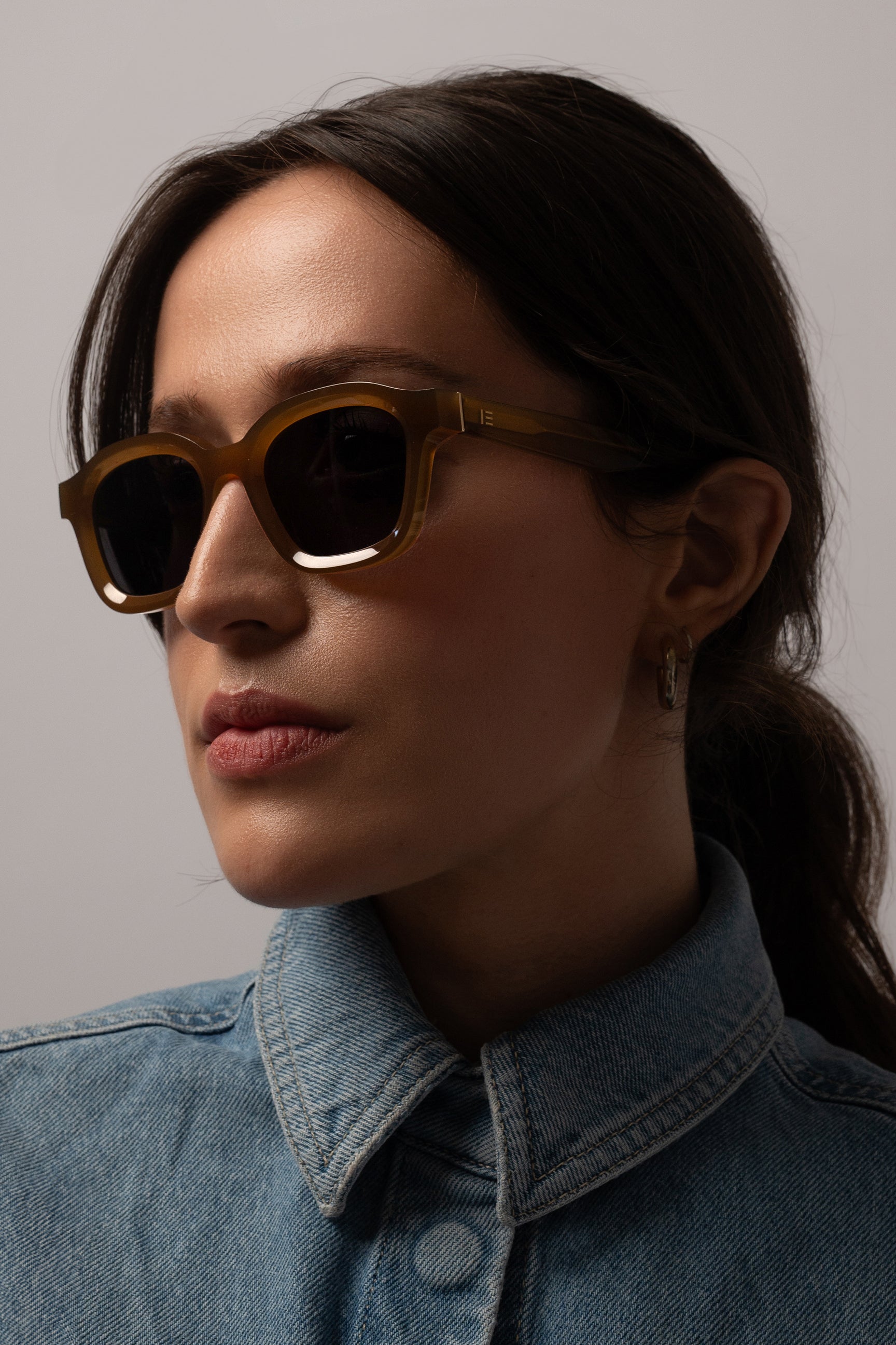 Female model wearing Isle of Eden Harley dijon sunglasses, angled portrait