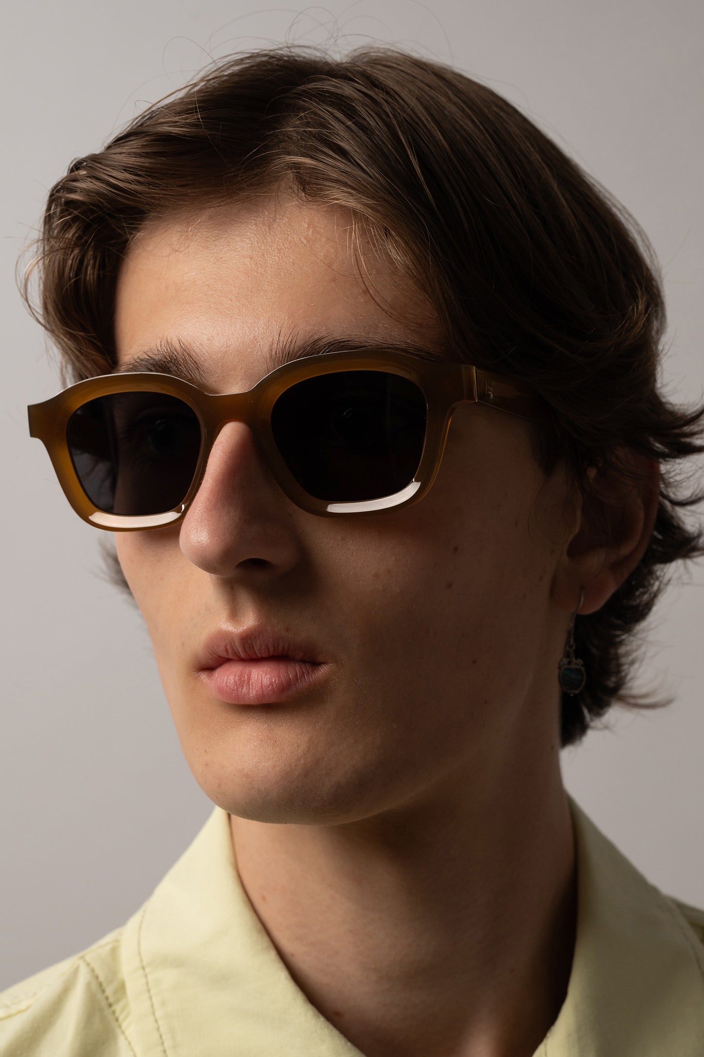 Male model wearing Isle of Eden Harley dijon sunglasses, front-facing portrait looking directly at the camera