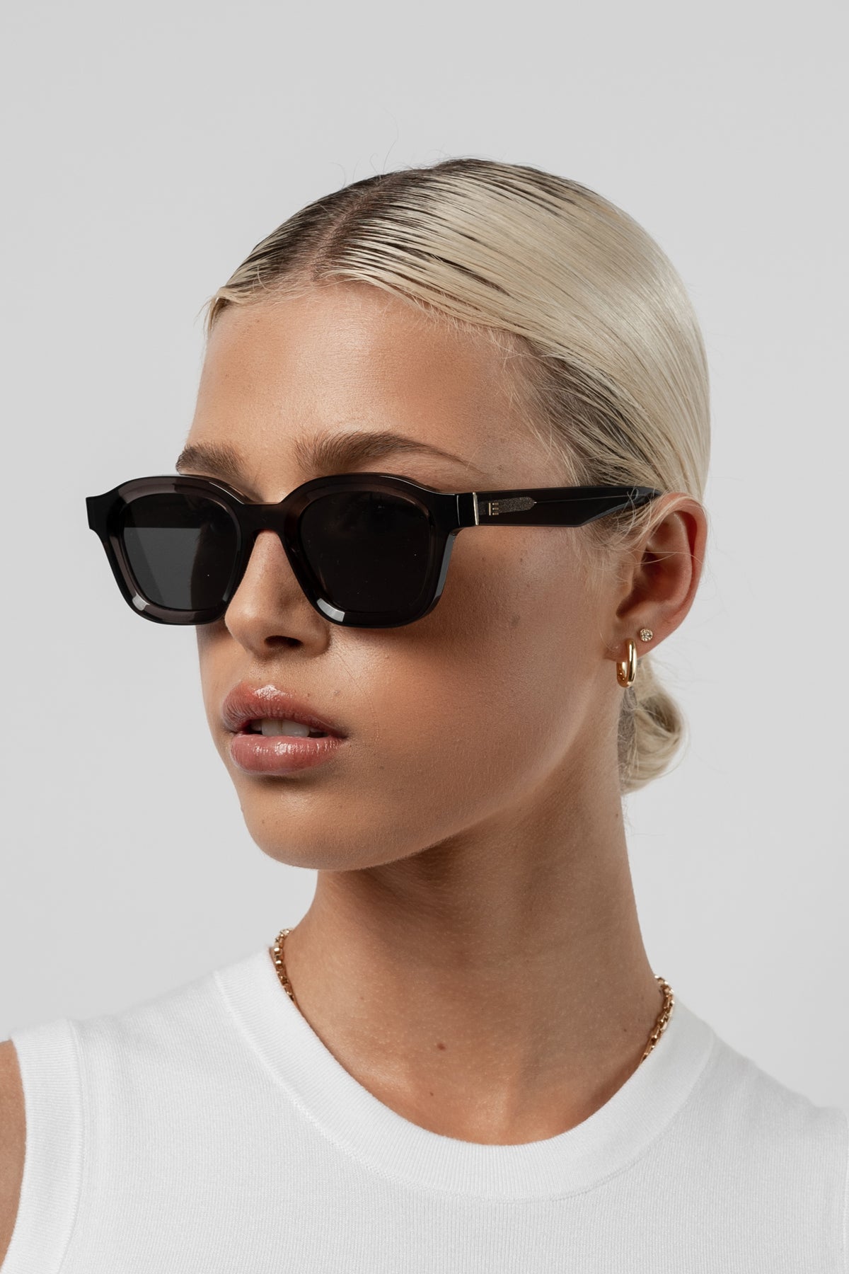Female model wearing Isle of Eden Harley grey sunglasses, front-facing portrait