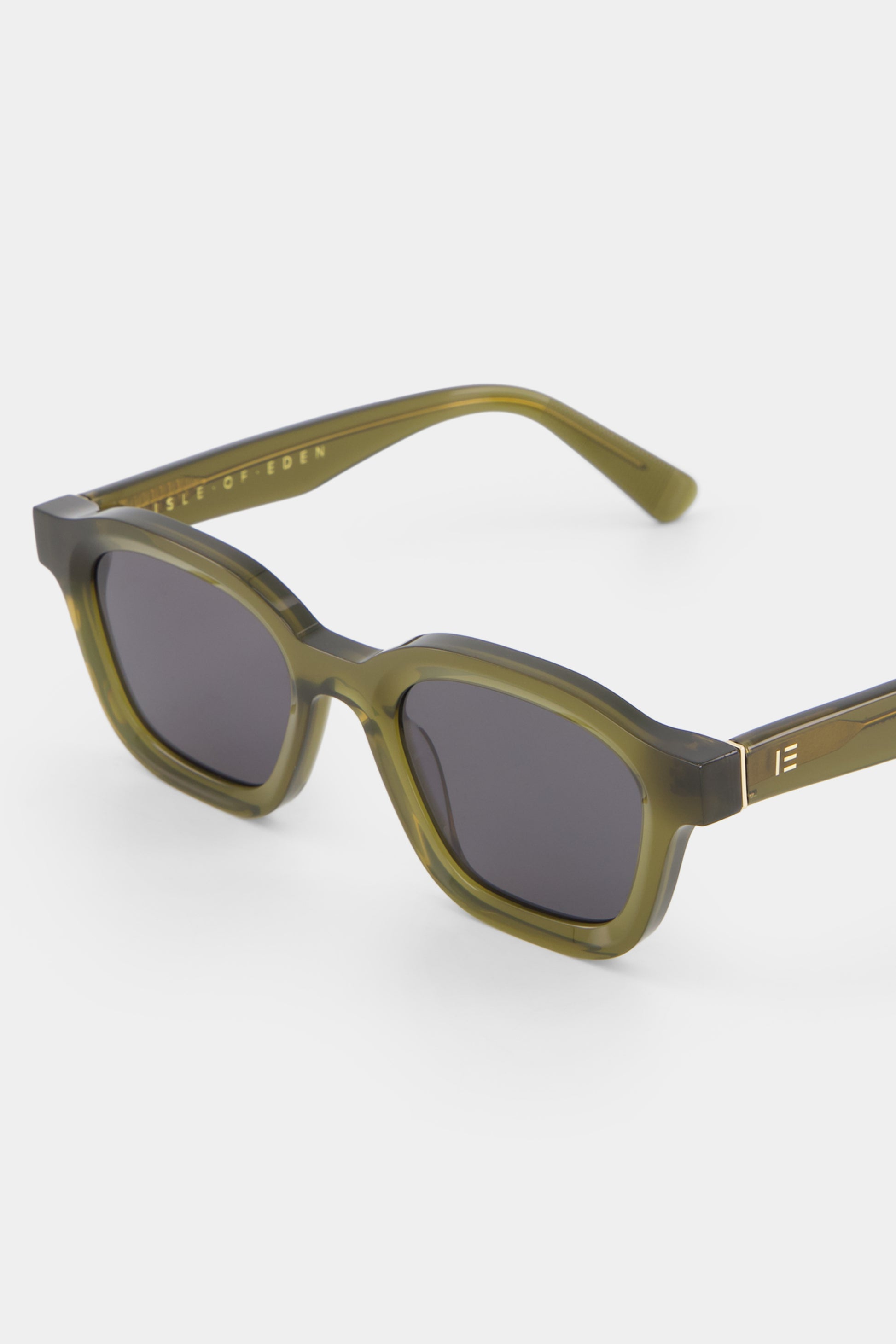 Close-up of Isle of Eden Harley frosted green sunglasses showing bold frame and brand lettering