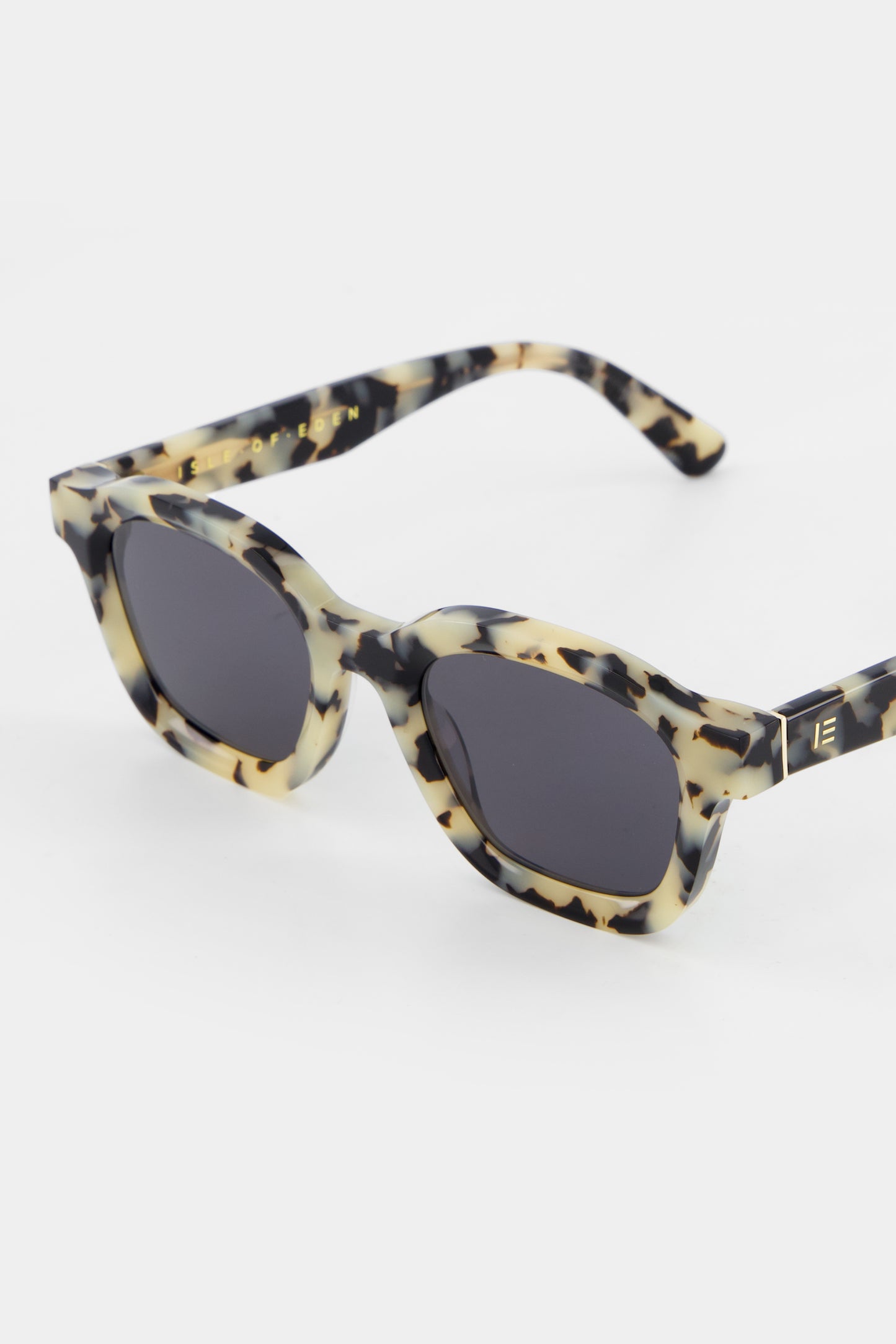 Close-up of Isle of Eden Harley white tortoise sunglasses showing bold frame and brand lettering