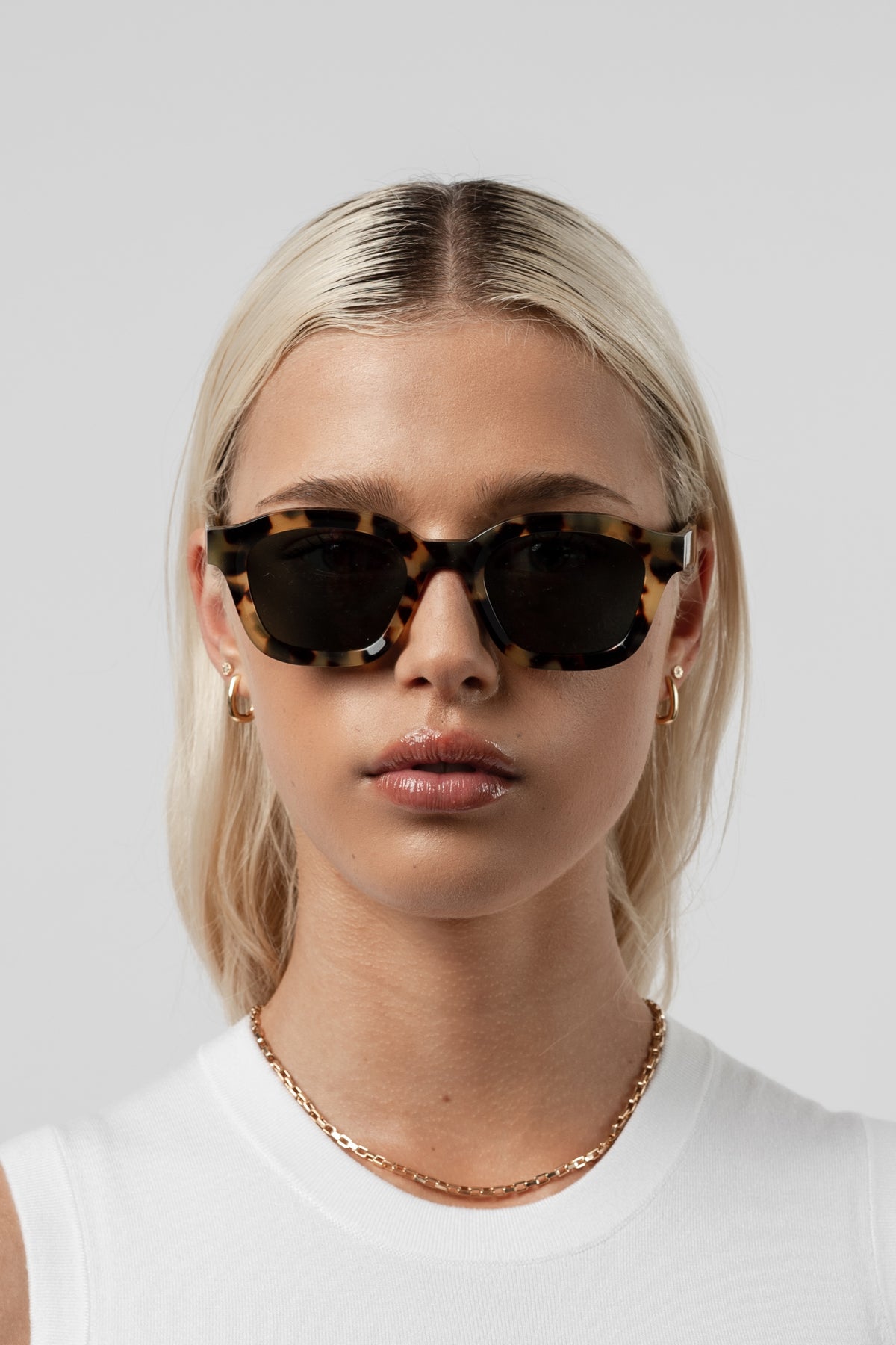 Female model wearing Isle of Eden Harley tortoise sunglasses, front-facing portrait looking directly at the camera