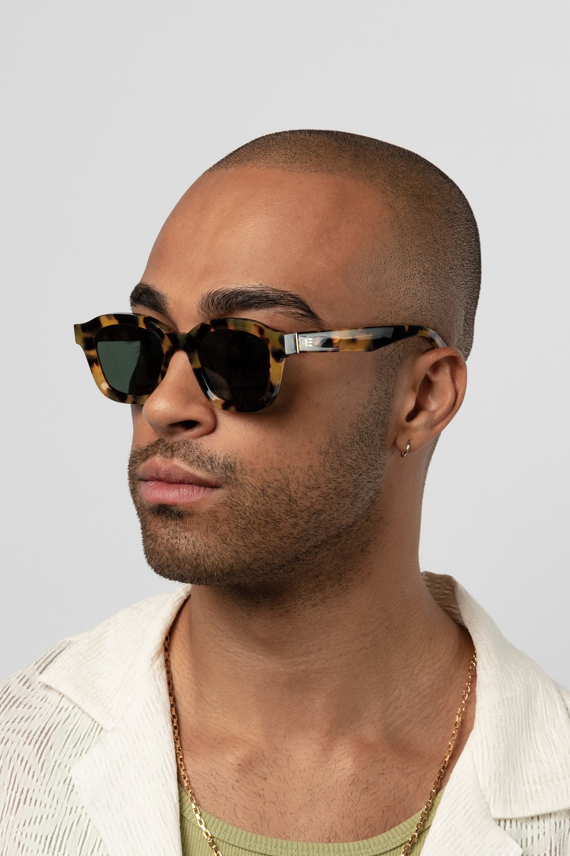 Male model wearing Isle of Eden Harley tortoise sunglasses, front-facing portrait looking directly at the camera