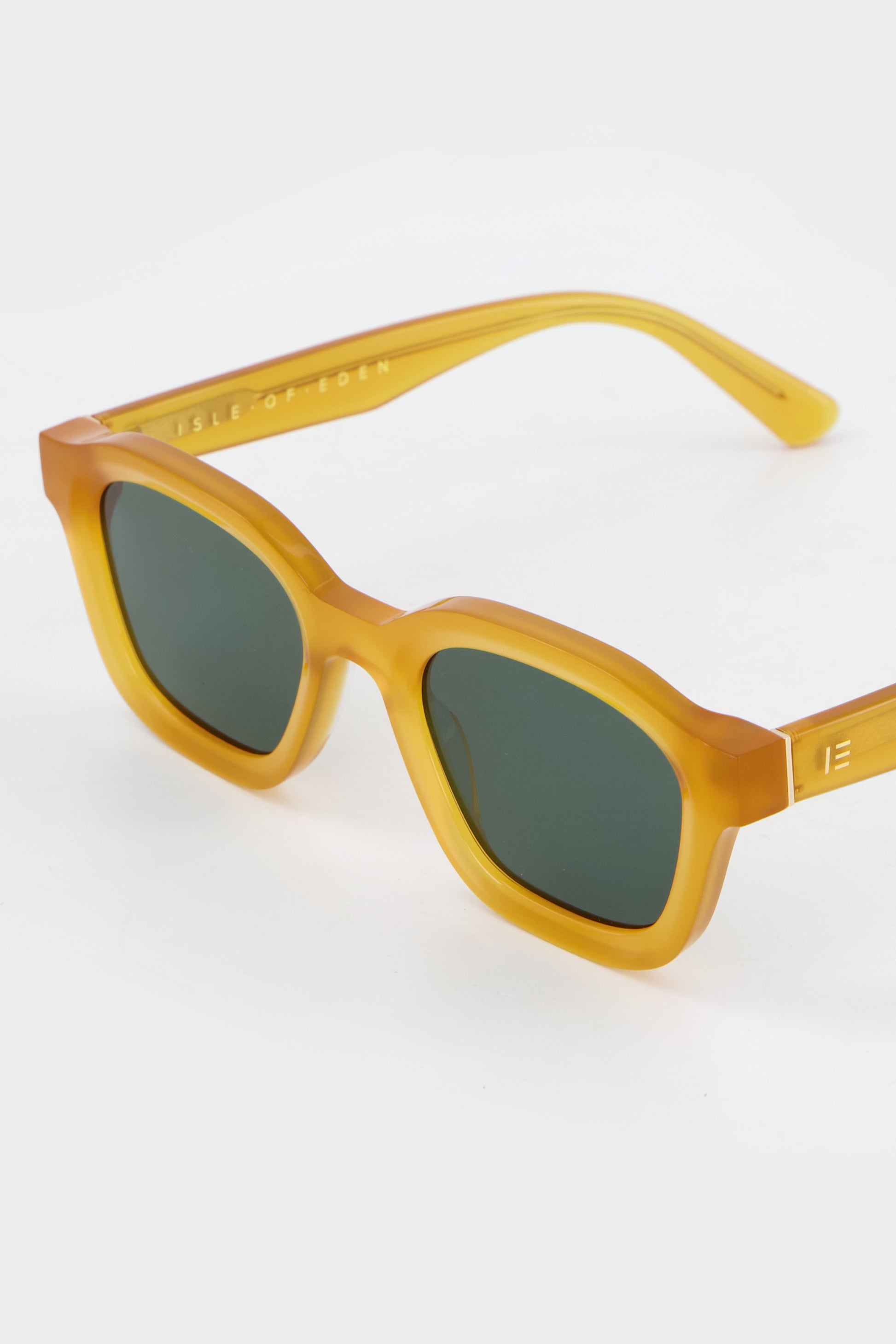 Close-up of Isle of Eden Harley yellow sunglasses showing bold frame and brand lettering