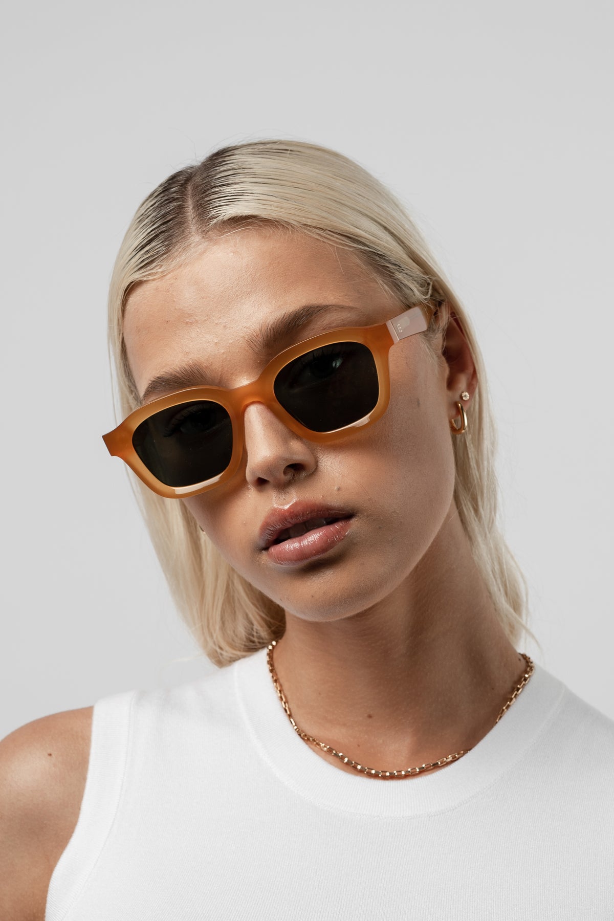 Female model wearing Isle of Eden Harley yellow sunglasses, close front-facing portrait
