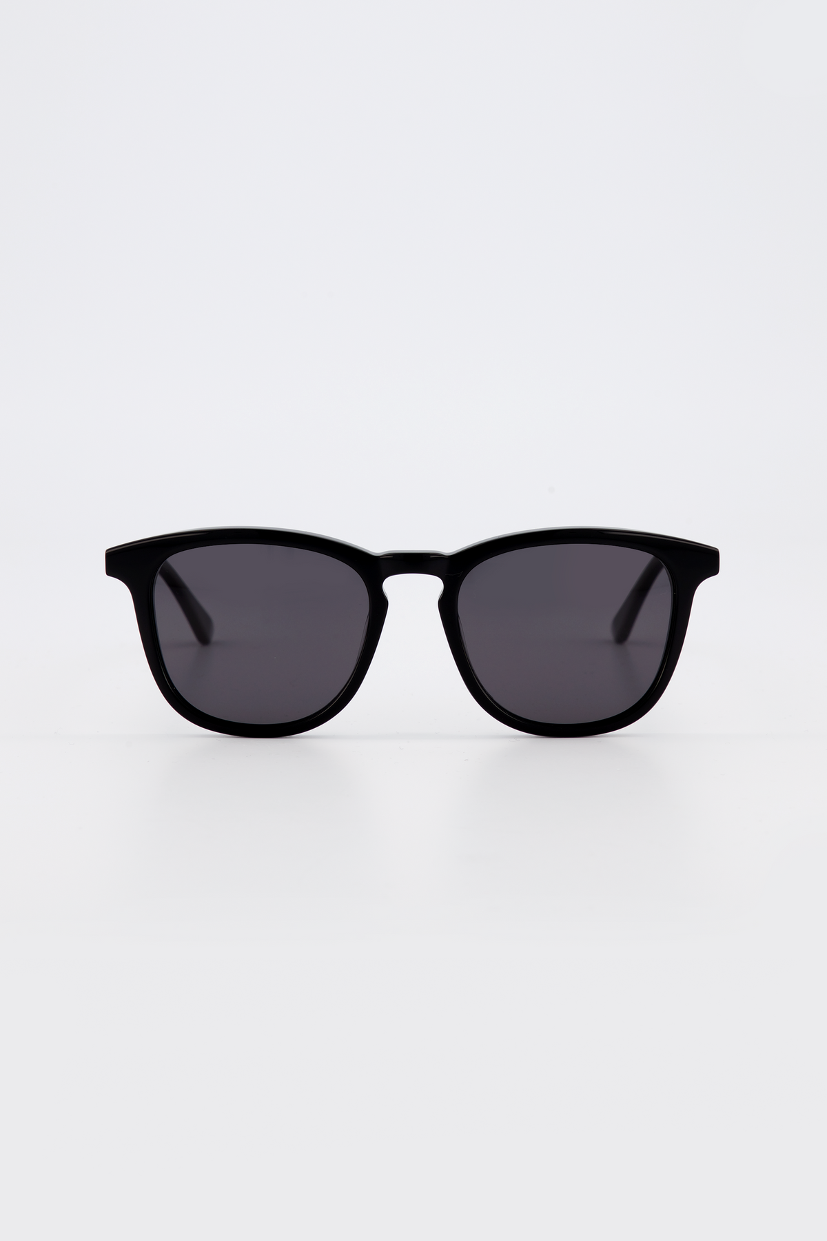 Isle of Eden Louis-Philippe black sunglasses, front view showing round bio-acetate frame and grey lenses