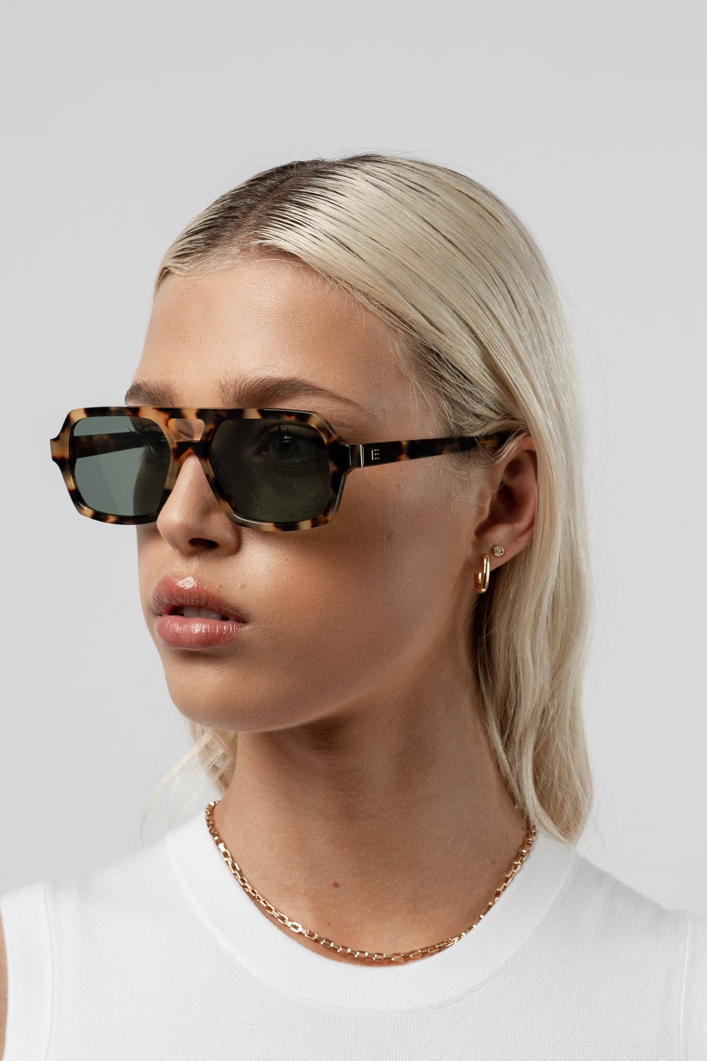 Female model wearing Isle of Eden Lola tortoise sunglasses, angled portrait