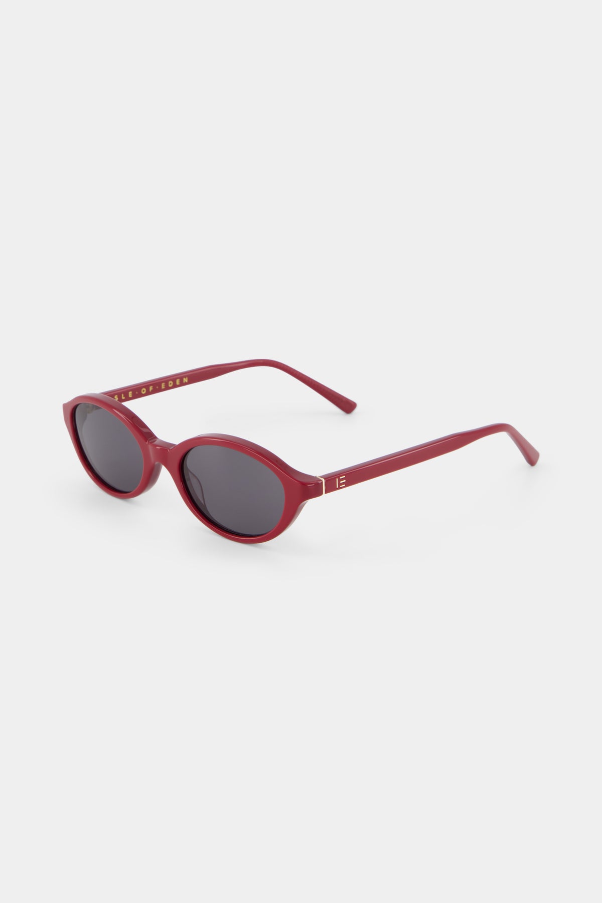 Isle of Eden Mirabel dark red sunglasses, three-quarter angle showing sleek oval frame