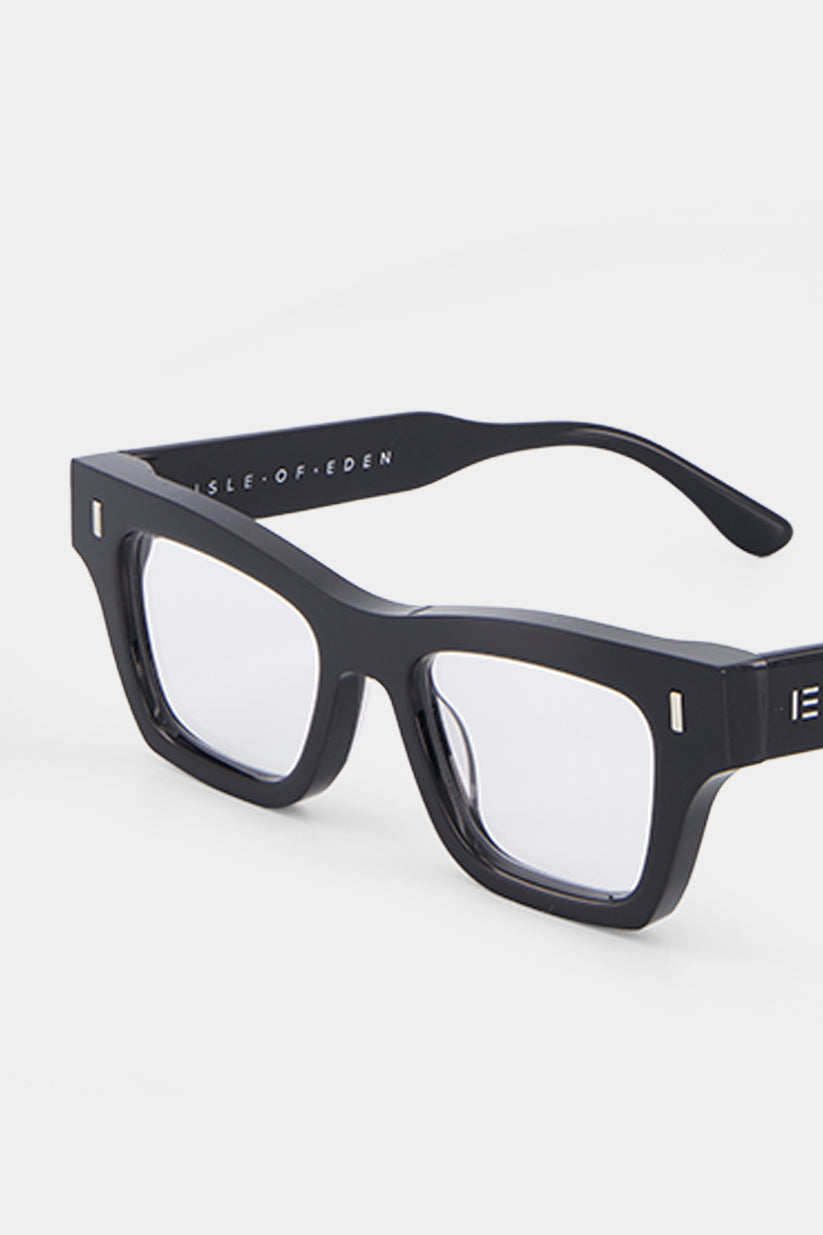 Isle of Eden Olli prescription glasses, angled side view showing the eco-conscious black bio-acetate frame with brand lettering detail
